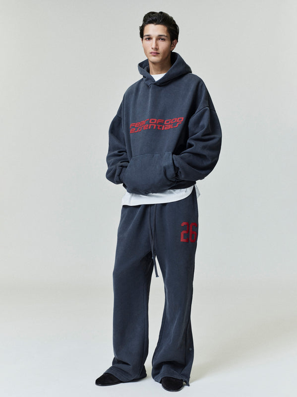Person wearing a vintage black tracksuit with red text on a white background