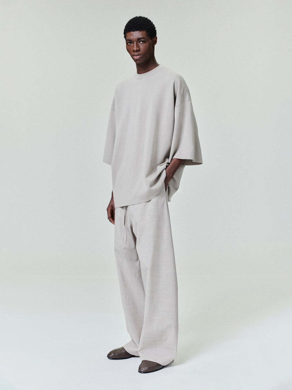 men's light beige oversized Merino Milano knit tee with voluminous drape and wide 3/4 length sleeves