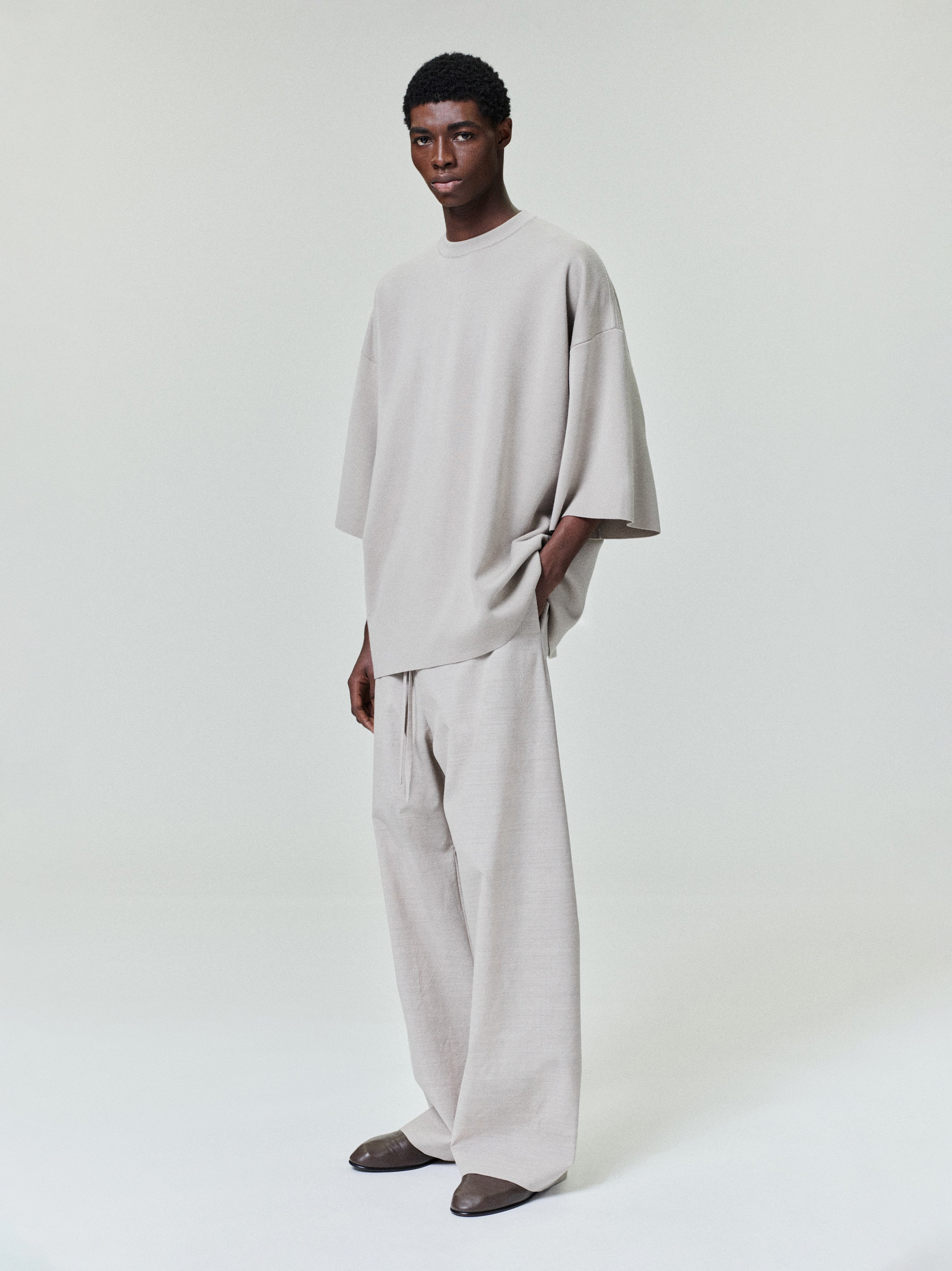 men's light beige oversized Merino Milano knit tee with voluminous drape and wide 3/4 length sleeves