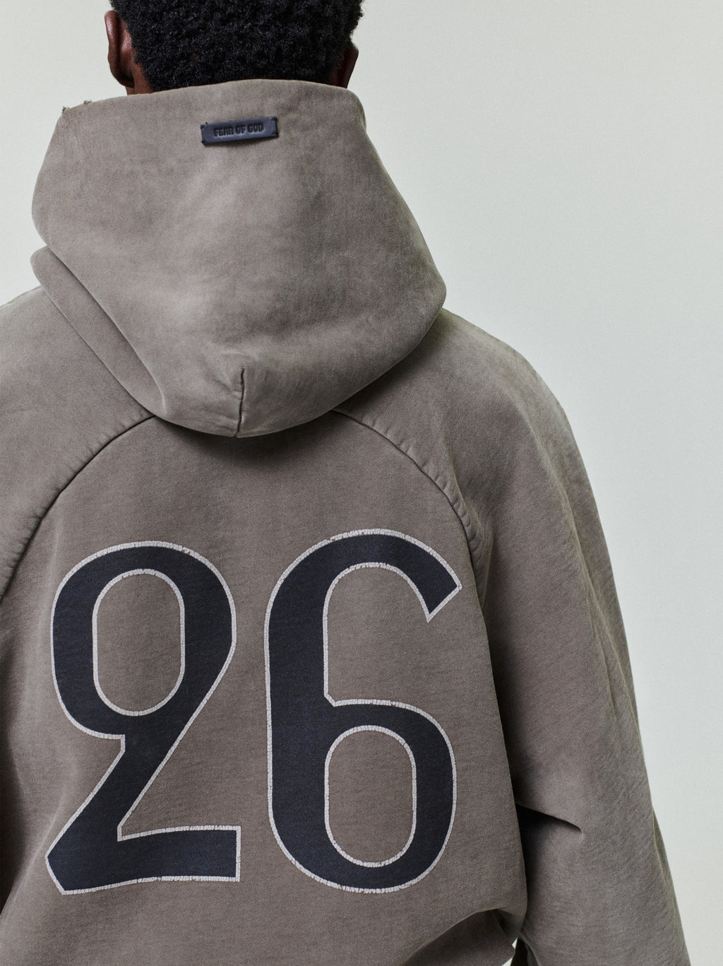 back view of sun-faded heavyweight cotton fleece hoodie with large hand-printed "26" graphic and raglan sleeves