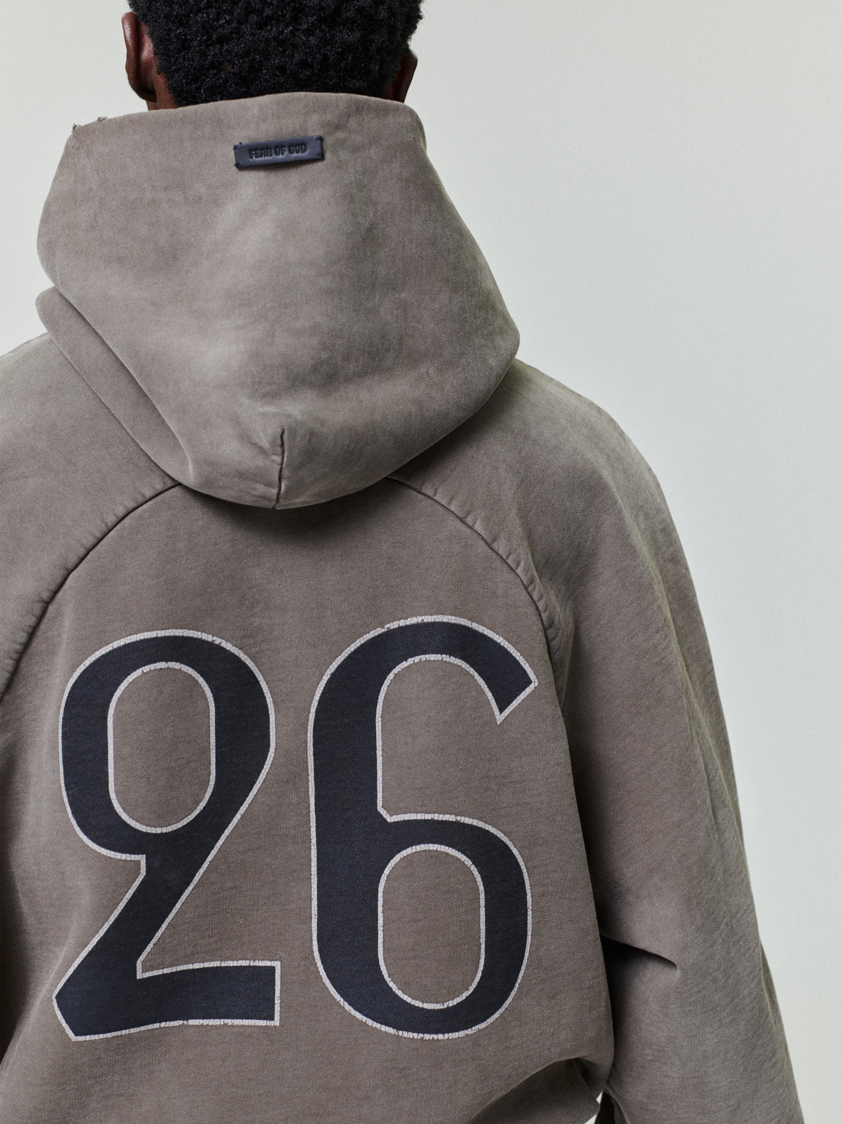 back view of sun-faded heavyweight cotton fleece hoodie with large hand-printed "26" graphic and raglan sleeves