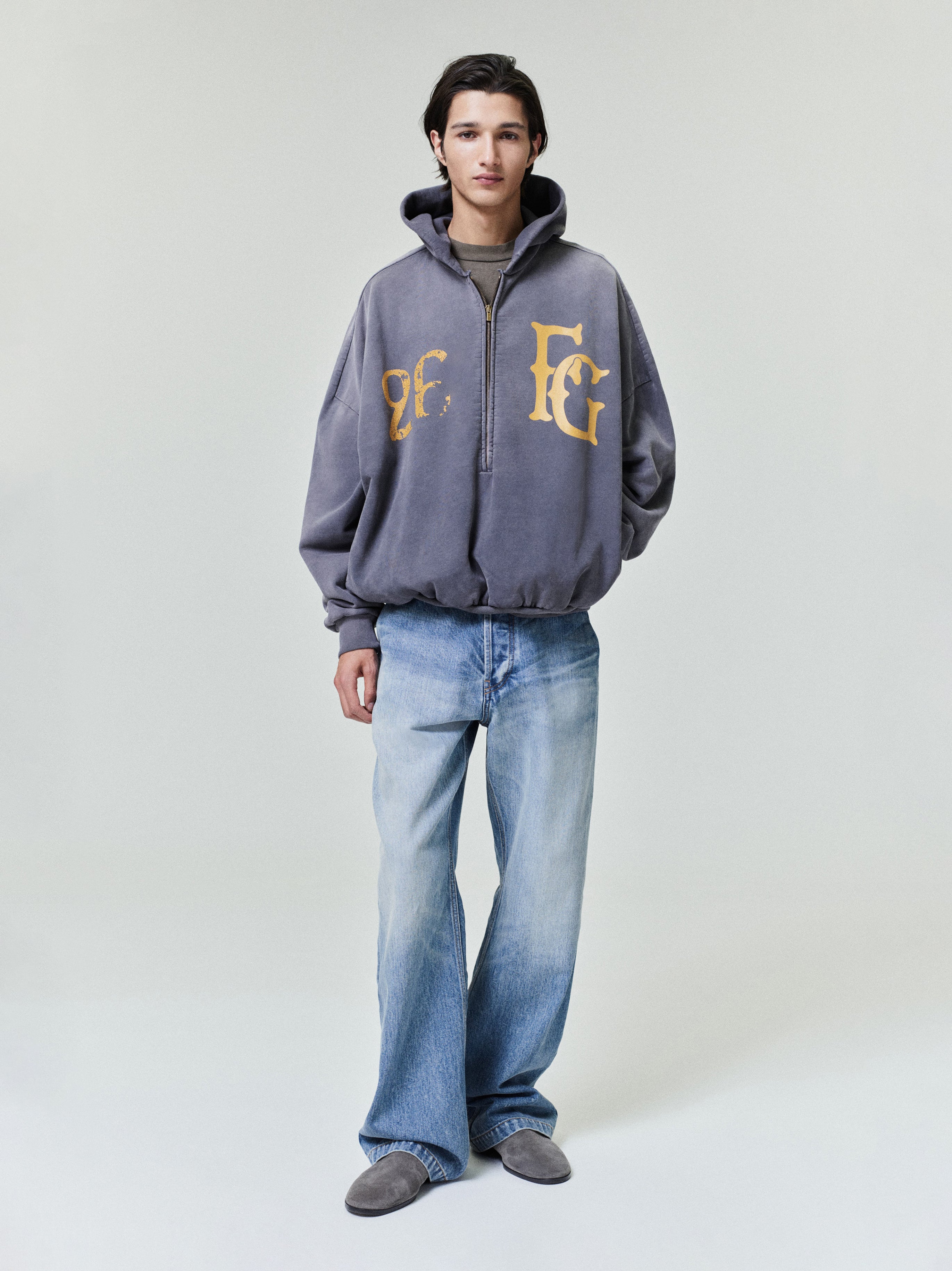 model wearing relaxed fit medium vintage wash denim utility pants with front pockets and casual sneakers