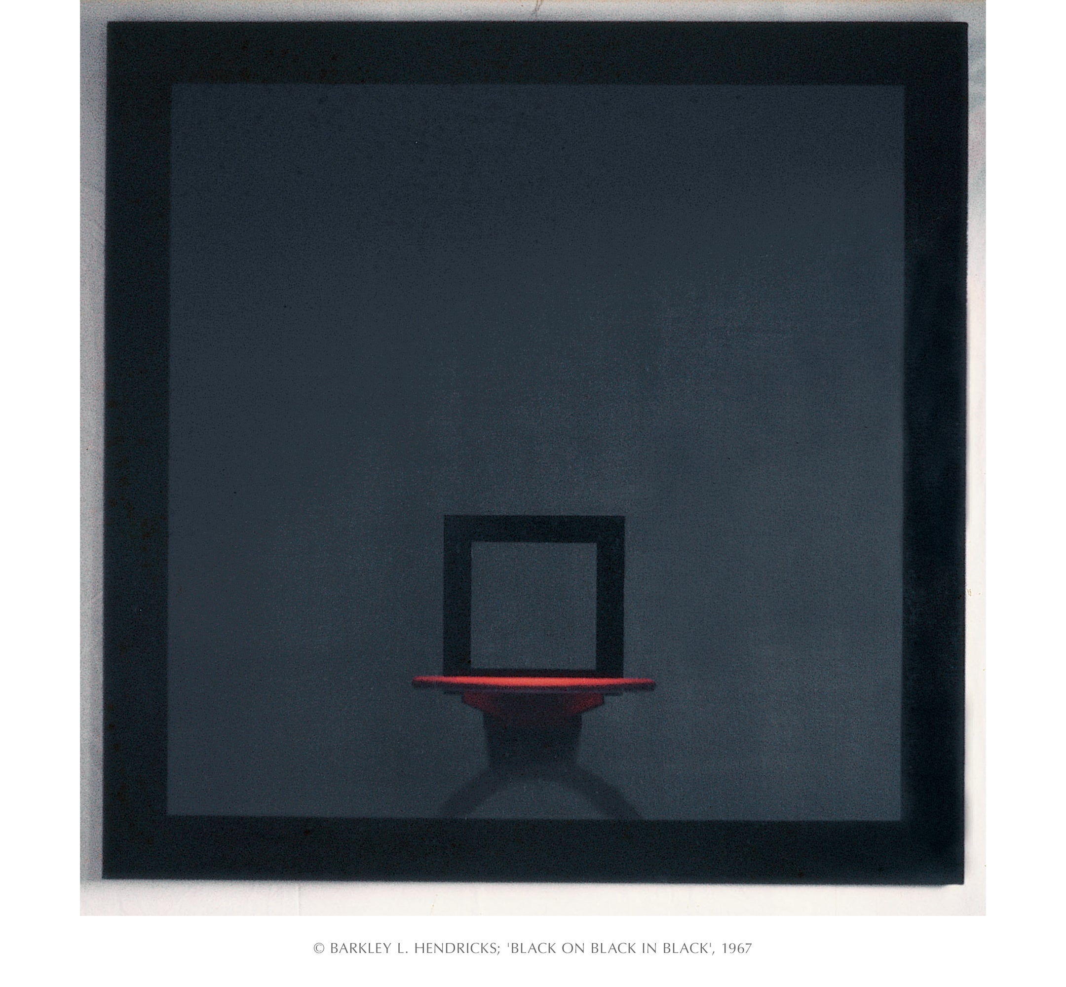 Abstract art piece with a black square backboard and red rim on a dark gray background.  Title 
