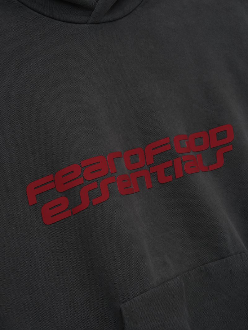 Black hoodie with red 'FEAR OF GOD ESSENTIALS' text on a dark background