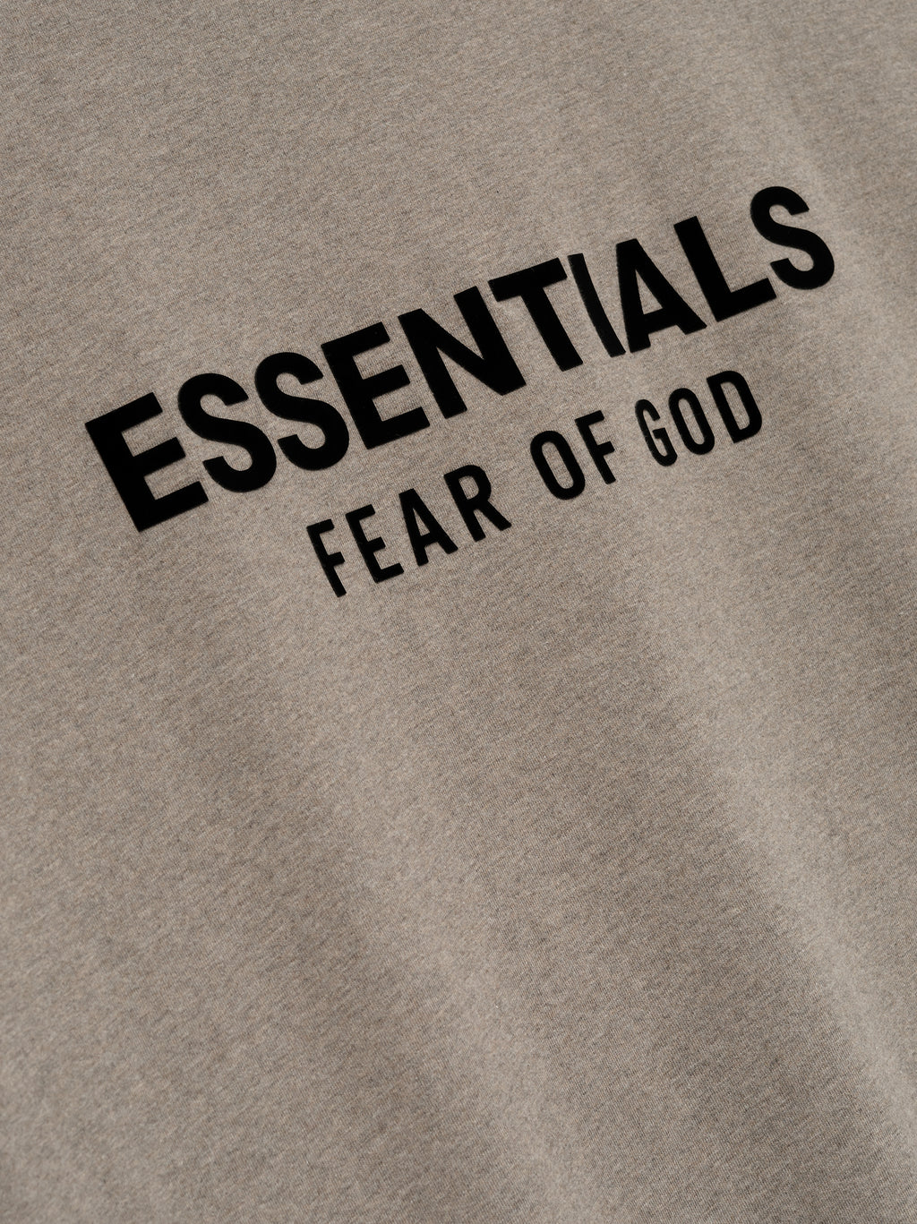 Close-up of Homestead Heather Classic Short Sleeve Tee showing black ESSENTIALS Fear of God logo on chest, gallery image 0