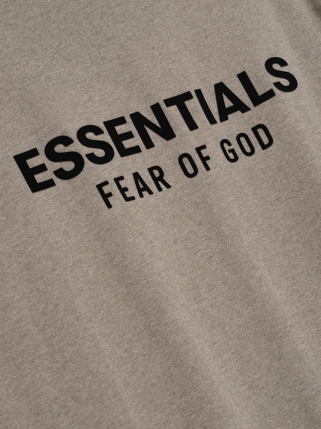 Taupe classic long sleeve tee with bold black ESSENTIALS Fear of God logo printed on chest area in clean font
