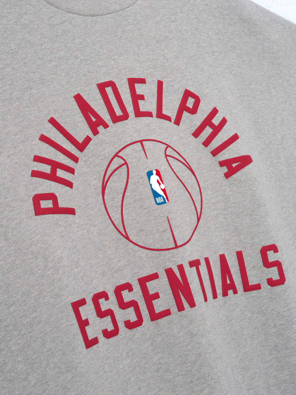 light grey heavy cotton jersey tee with red Philadelphia Essentials text and NBA logo basketball graphic center chest