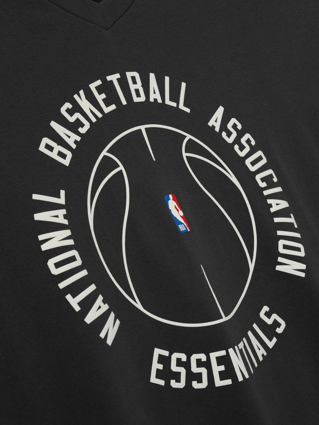 black oversized heavy cotton V-neck long sleeve tee with circular NBA Essentials basketball outline and logo center chest