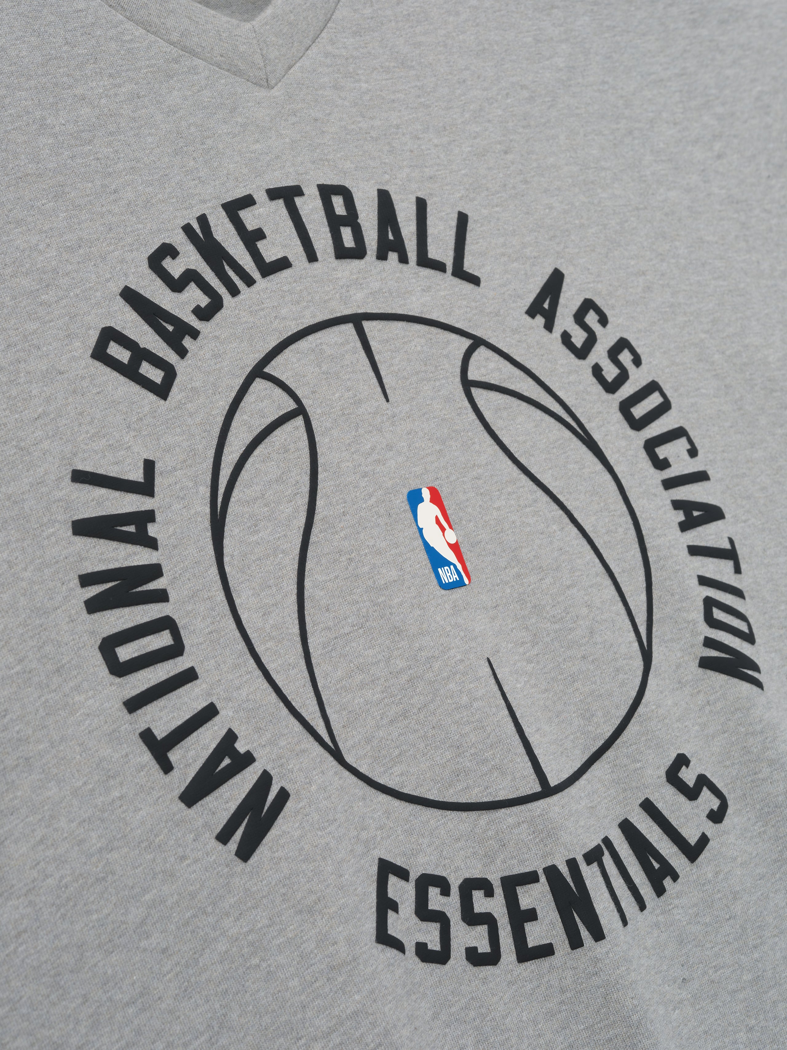 grey heavy cotton long sleeve V-neck tee with minimalist NBA Essentials basketball outline graphic center chest