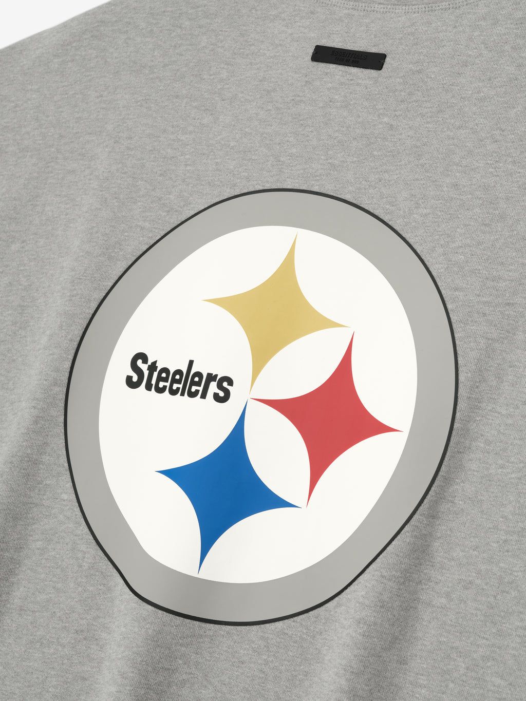 Close-up of concrete heather Steelers 90s 3/4 Sleeve Football Tee showing large vintage Steelers logo on front chest