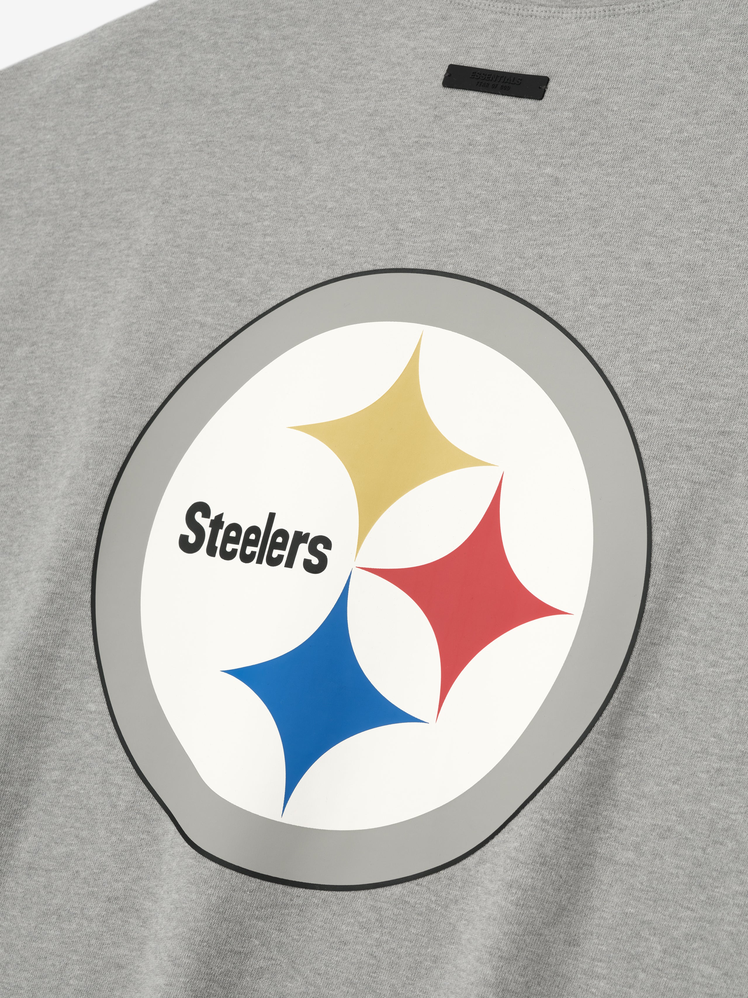 Close-up of concrete heather Steelers 90s 3/4 Sleeve Football Tee showing large vintage Steelers logo on front chest