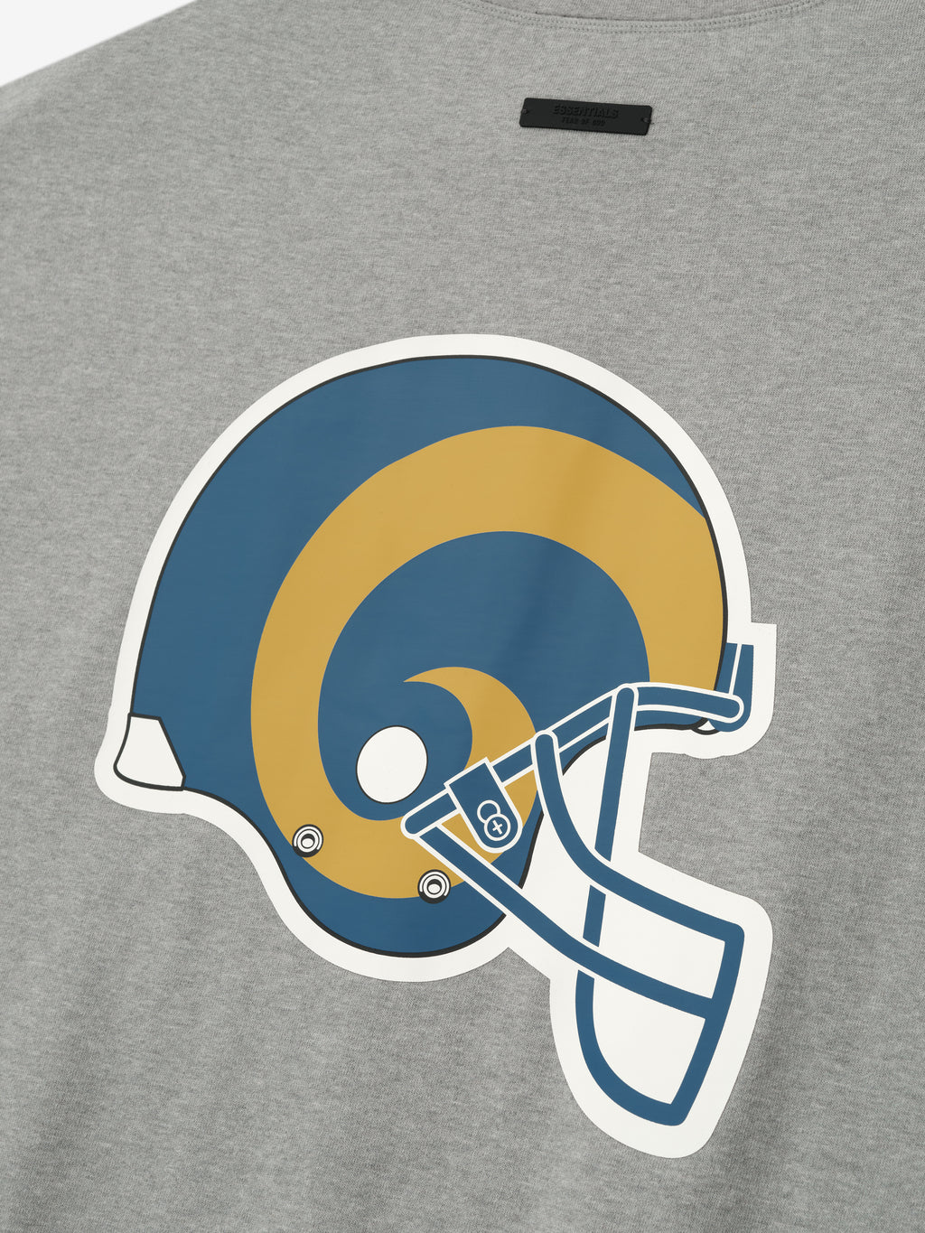 Close-up of concrete heather Rams 90s 3/4 Sleeve Football Tee showing large blue and gold Rams helmet graphic on chest