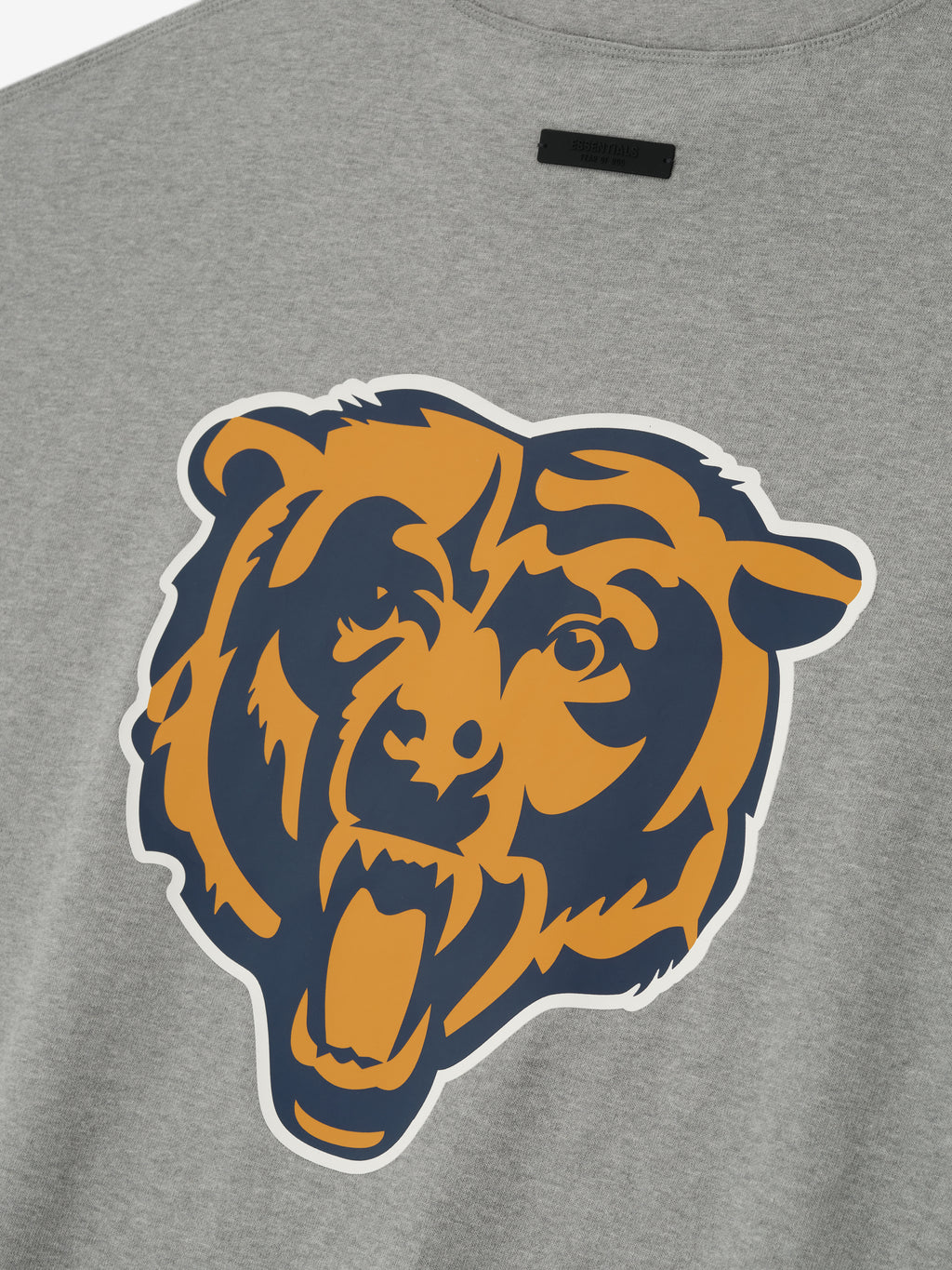 Close-up of concrete heather Bears 90s 3/4 Sleeve Football Tee showing large navy and gold roaring bear graphic on back