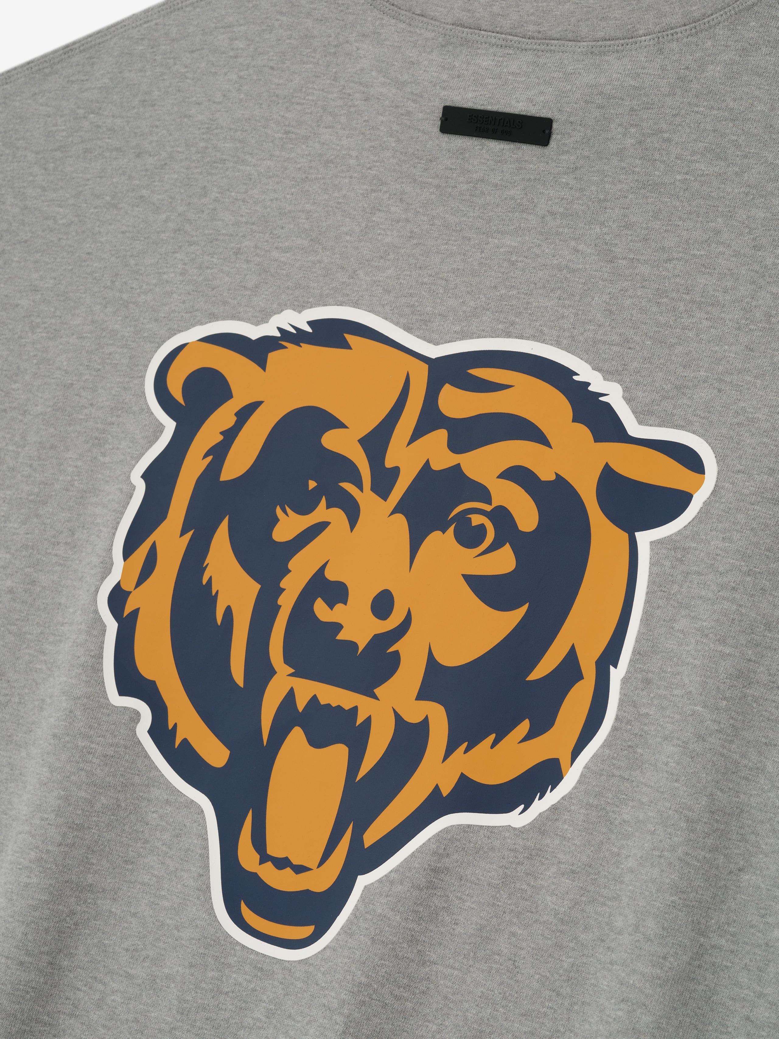 Close-up of concrete heather Bears 90s 3/4 Sleeve Football Tee showing large navy and gold roaring bear graphic on back