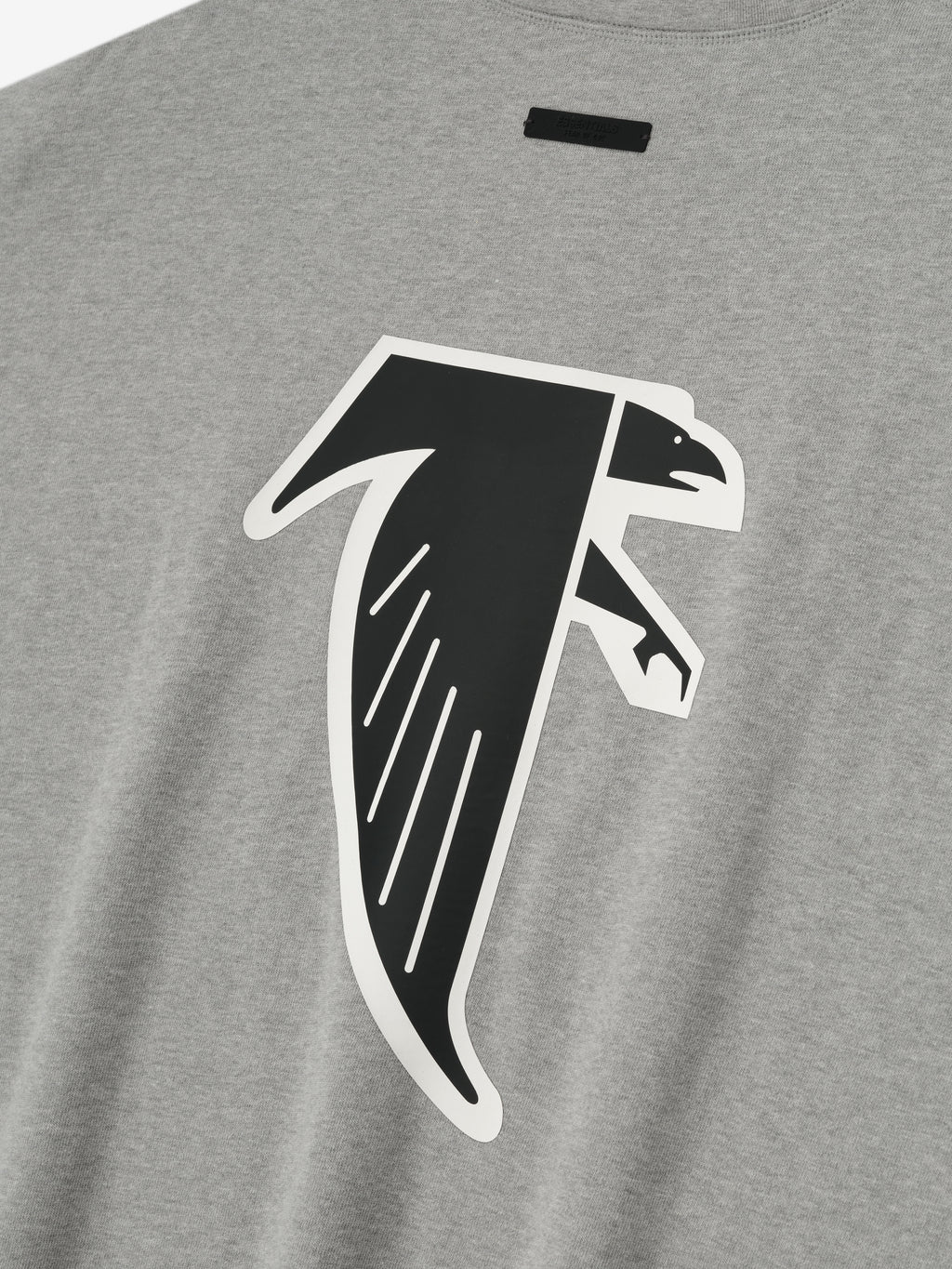 Close-up of concrete heather Falcons 90s 3/4 Sleeve Football Tee featuring large black and white falcon graphic on chest