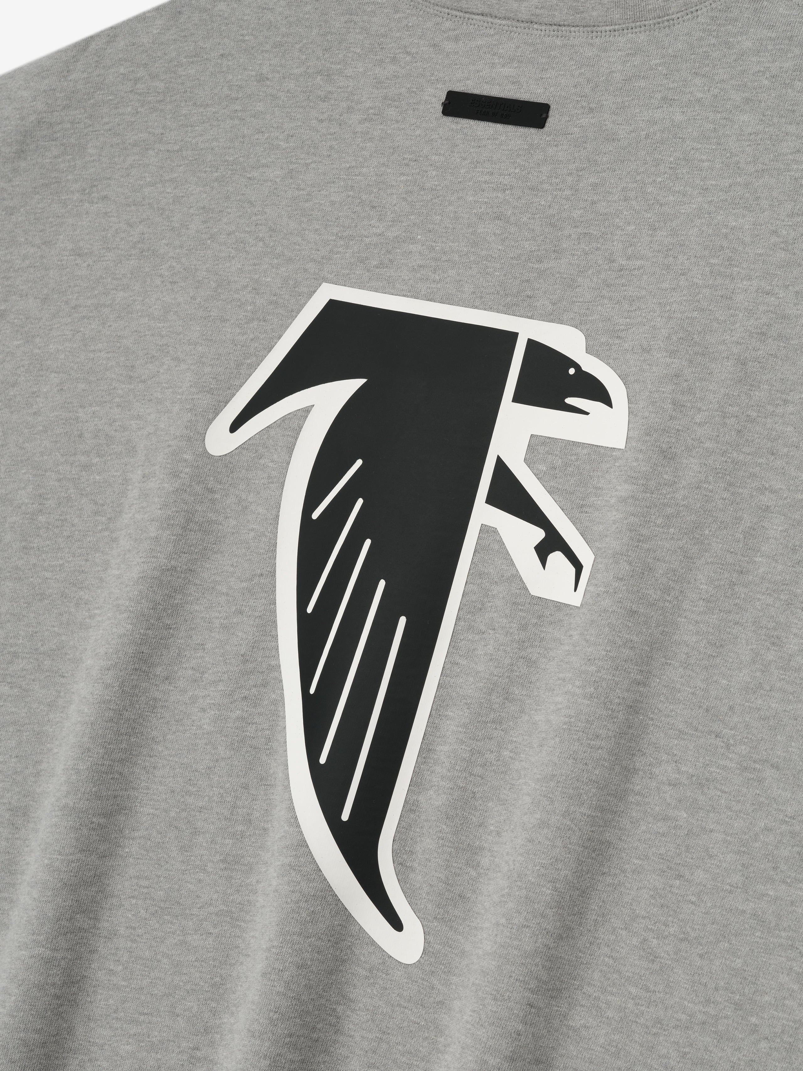 Close-up of concrete heather Falcons 90s 3/4 Sleeve Football Tee featuring large black and white falcon graphic on chest