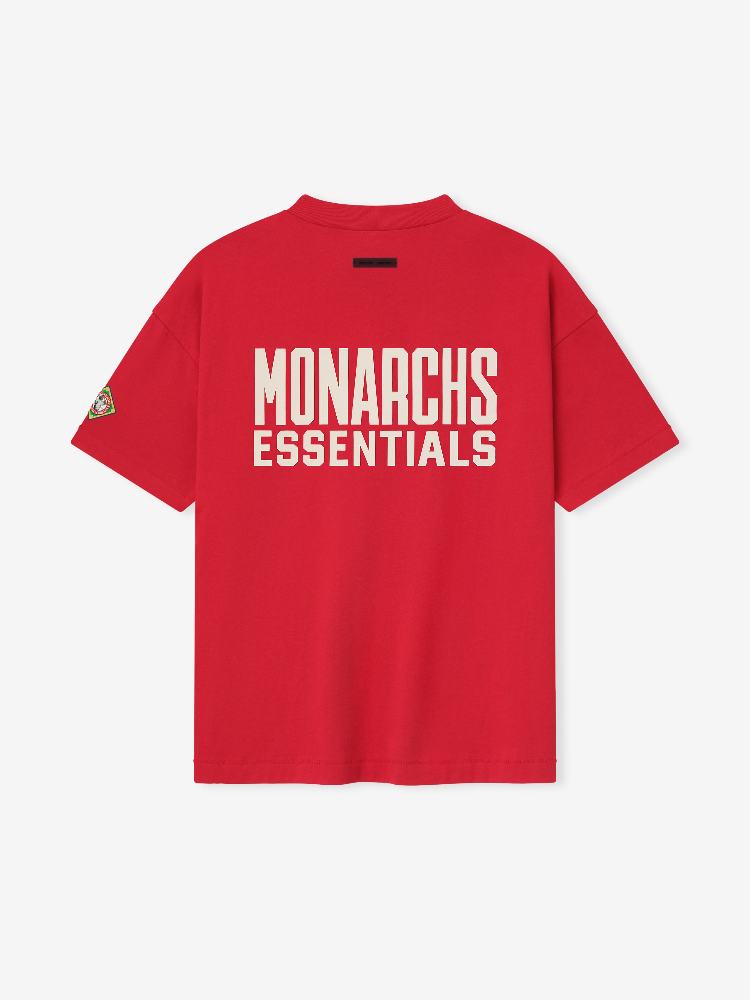 Back view of red Essentials FG Monarchs Tee with large white MONARCHS ESSENTIALS text and sleeve patch, gallery image 0