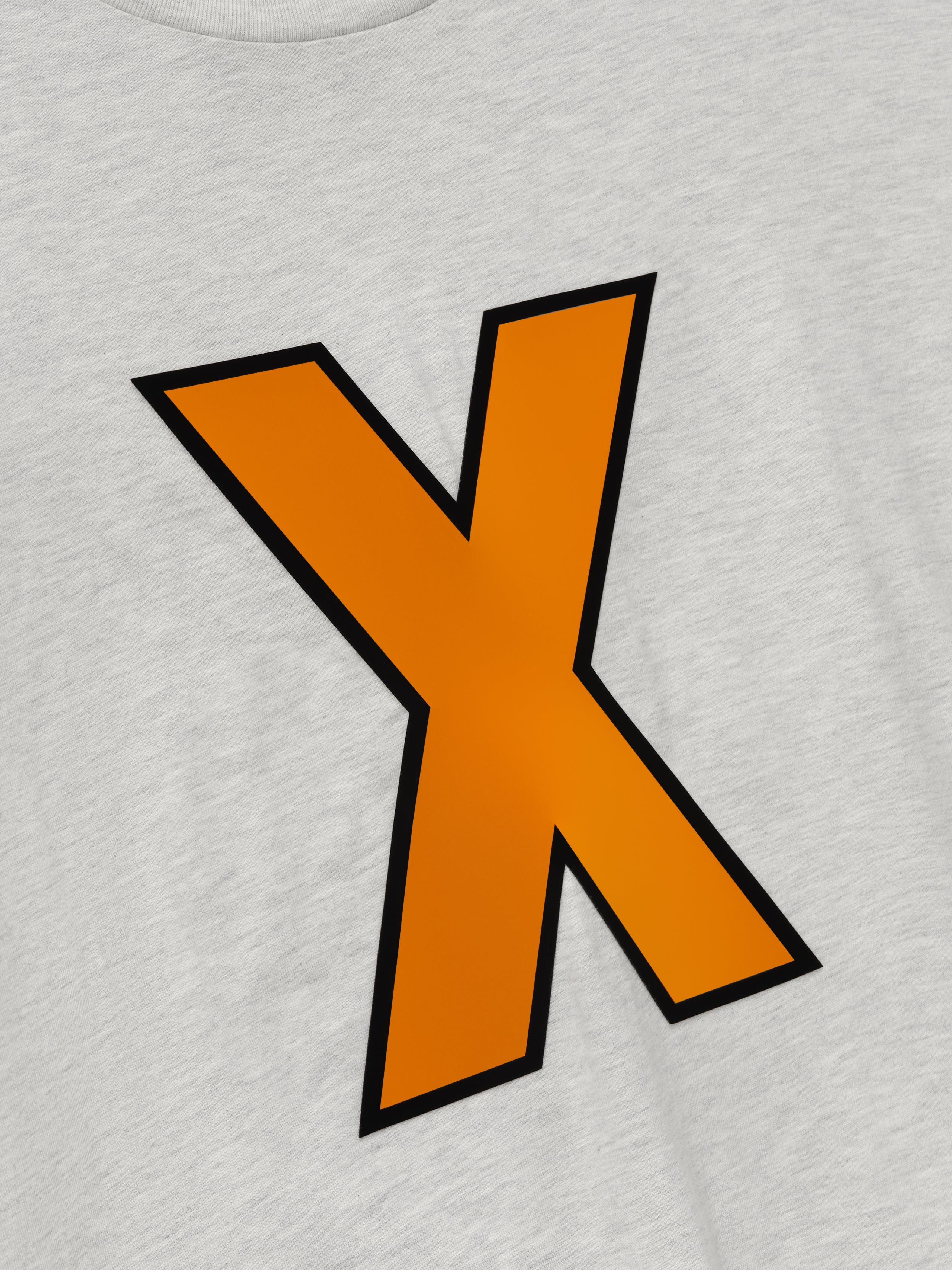 close-up of light gray cotton tee with large orange "X" outlined in black printed on front