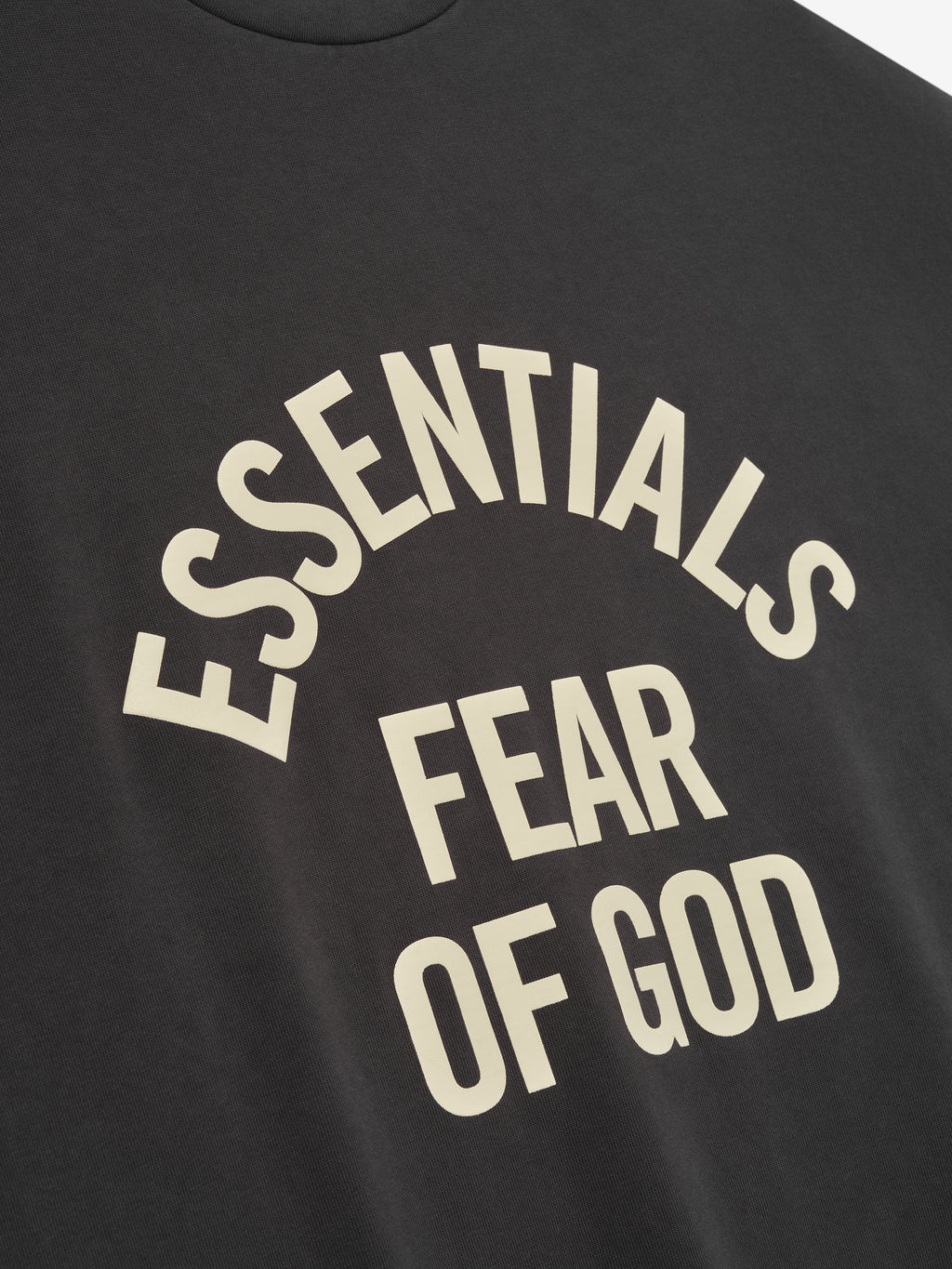Black t-shirt with 'ESSENTIALS FEAR OF GOD' text in beige.