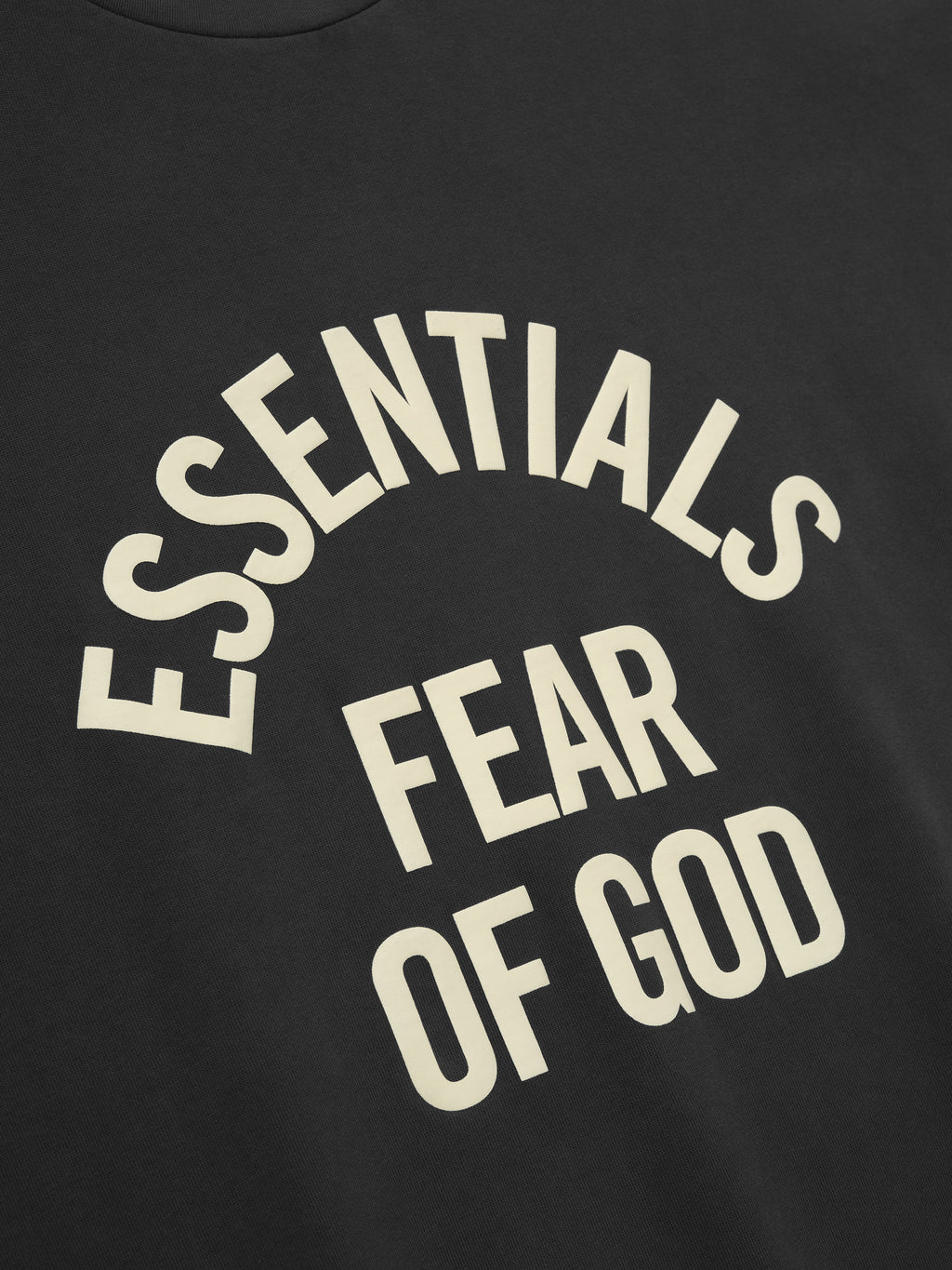 black heavyweight cotton long sleeve tee with vintage pigment dye and curved ESSENTIALS FEAR OF GOD text on front