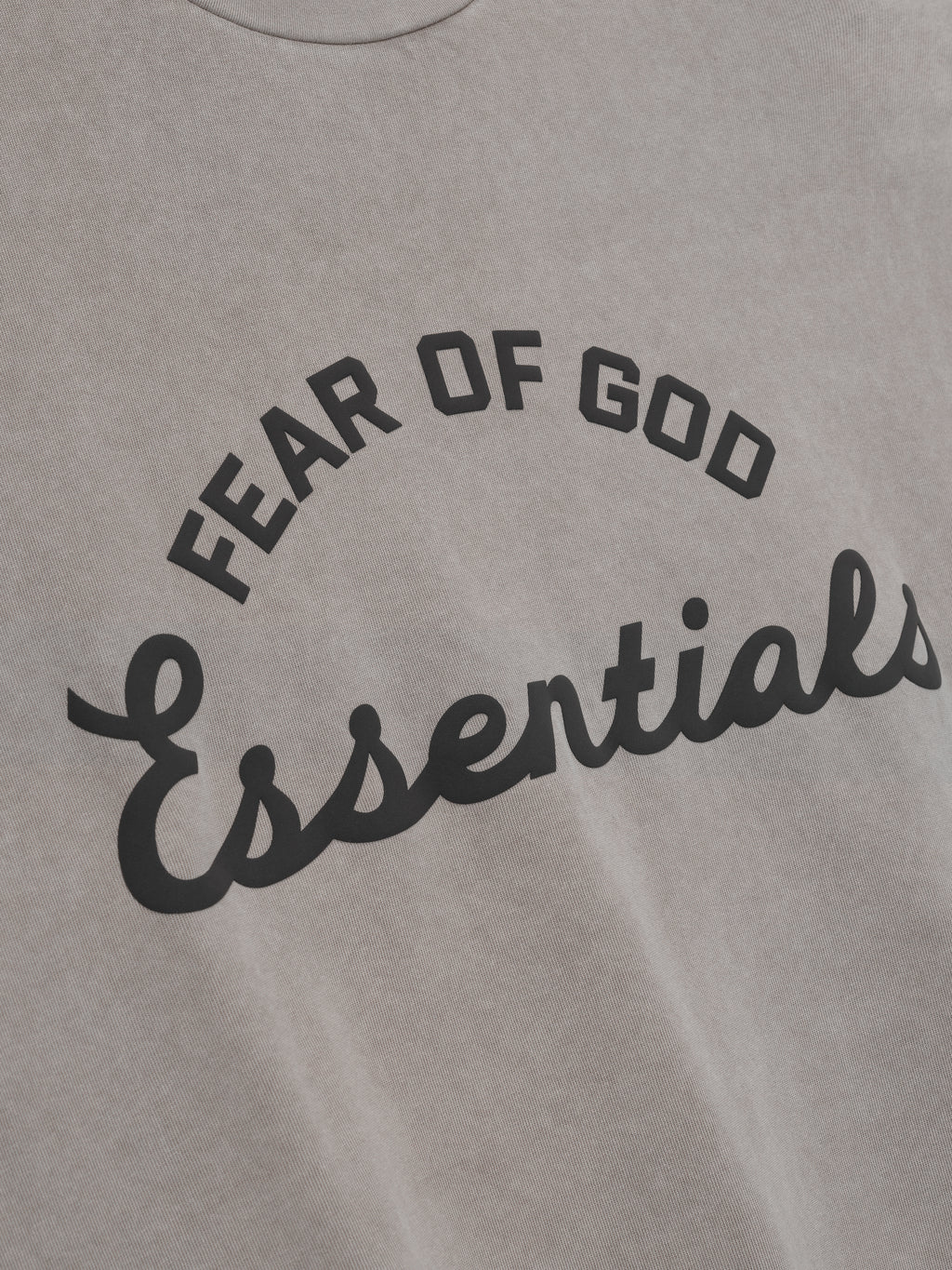Gray t-shirt with 'Fear of God Essentials' text in black on a plain background