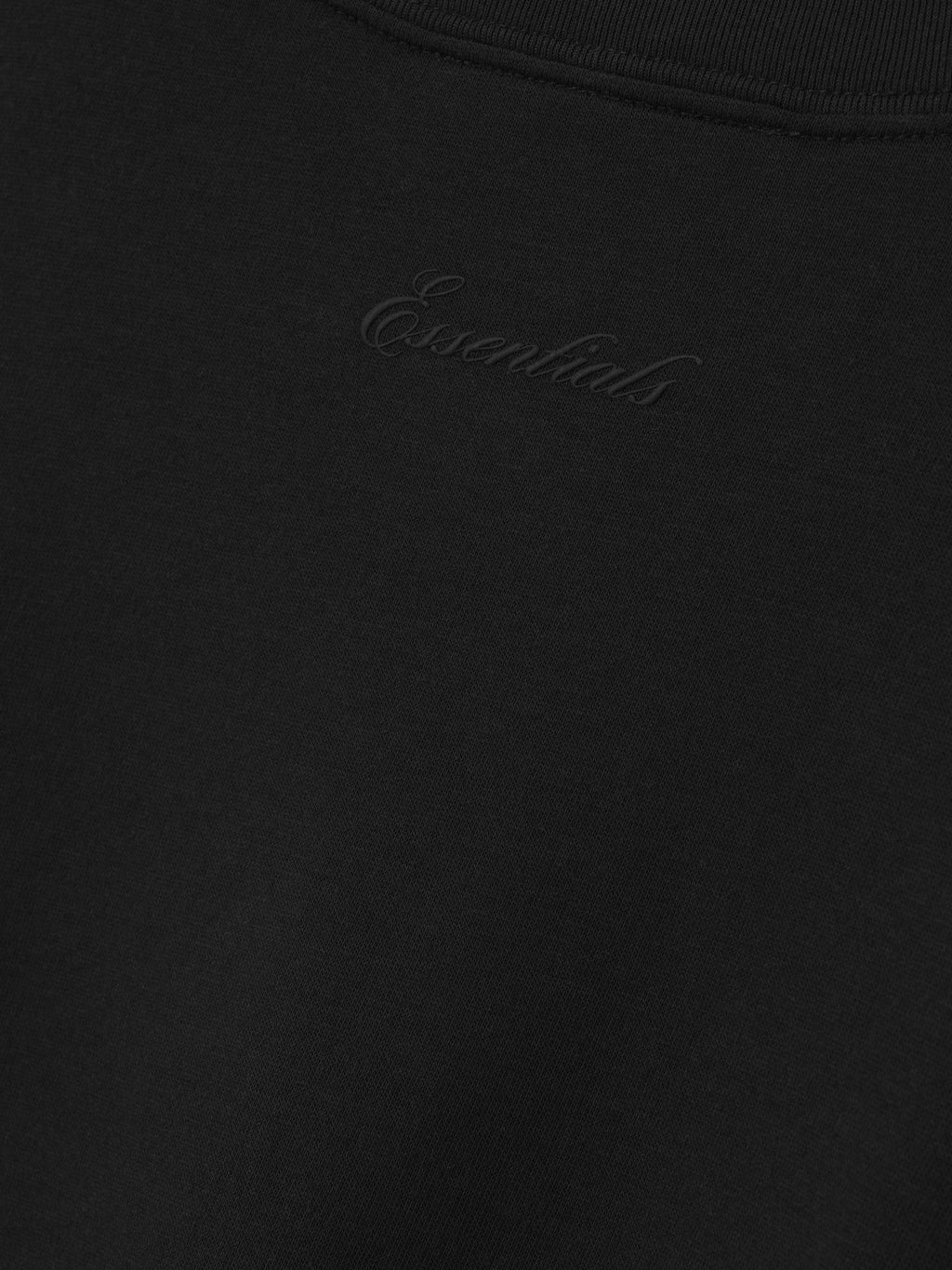 Black t-shirt with a brand logo on a plain background