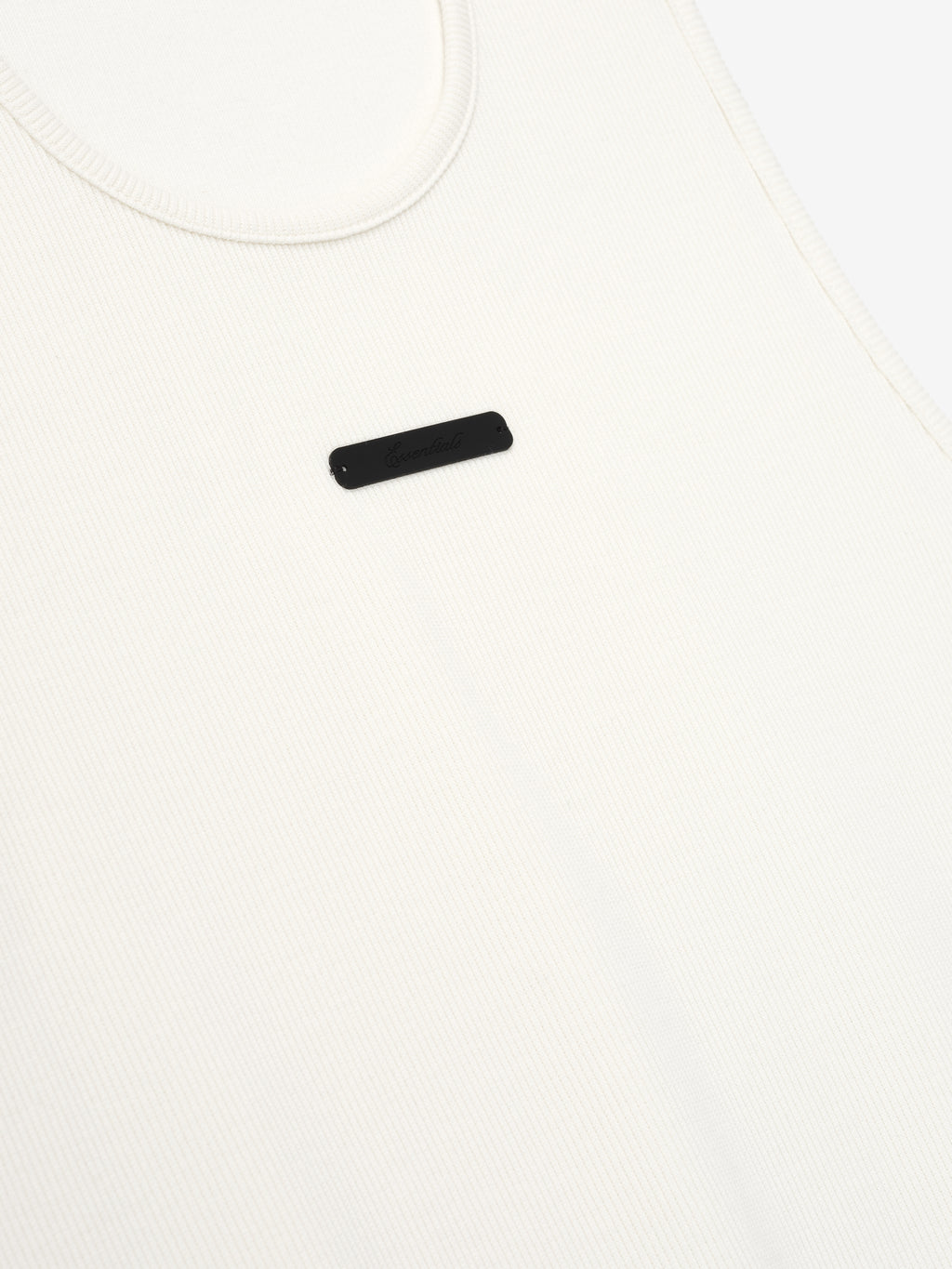 close-up of off-white ribbed cotton spandex tank top with minimalist Essentials signature LA logo on chest
