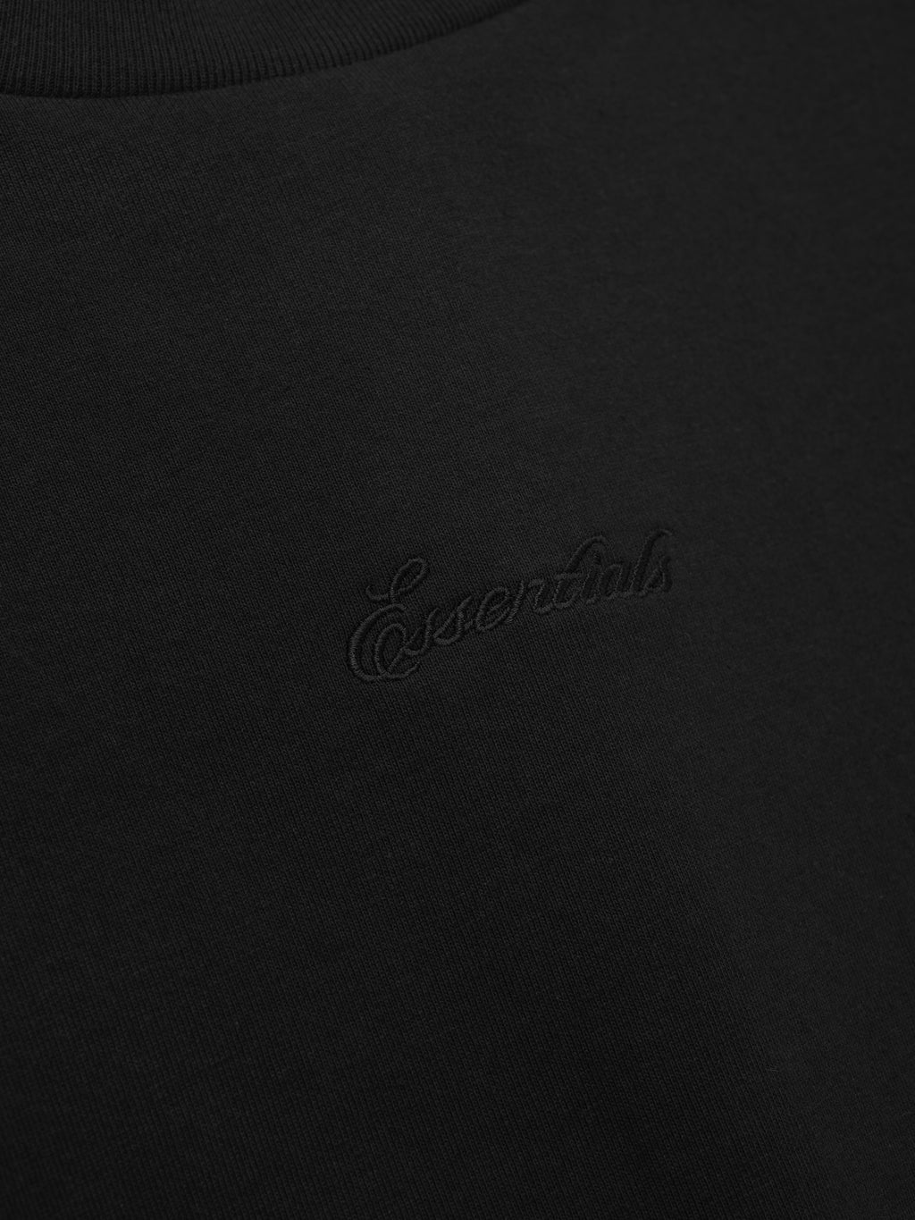 Close-up of a black tee with embroidery.