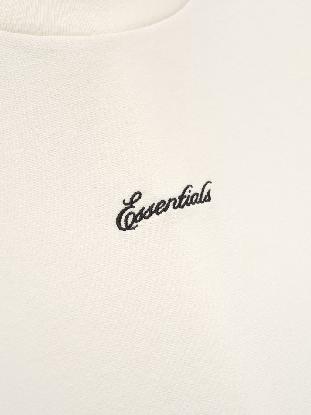 White t-shirt with 'essentials' embroidery. 