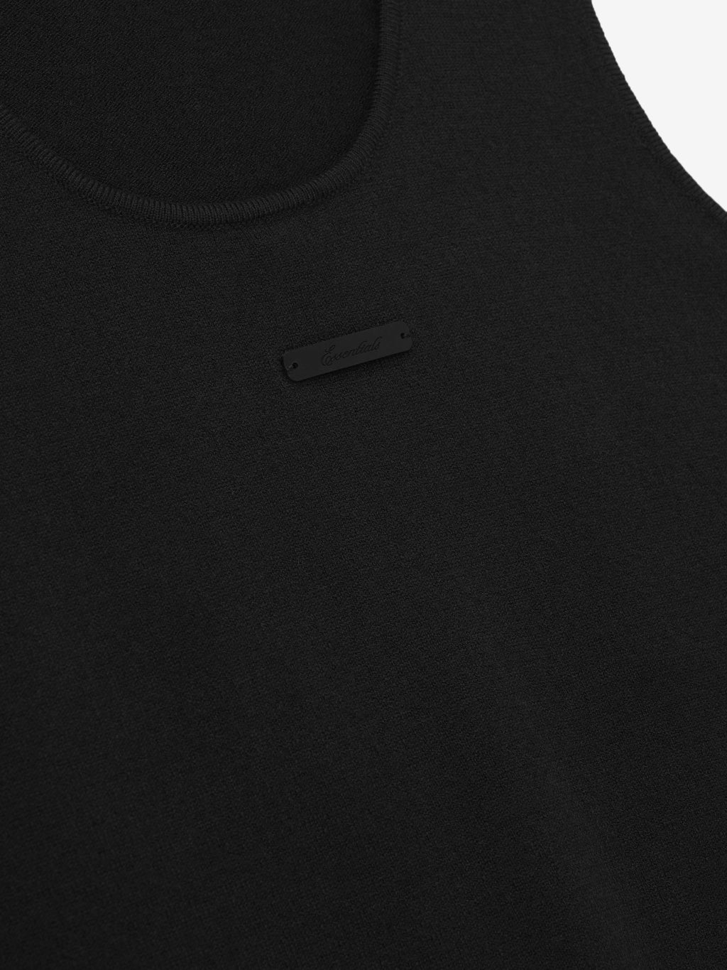 close-up of black knit tank top in soft jersey stitch featuring subtle tonal brand tag on front neckline