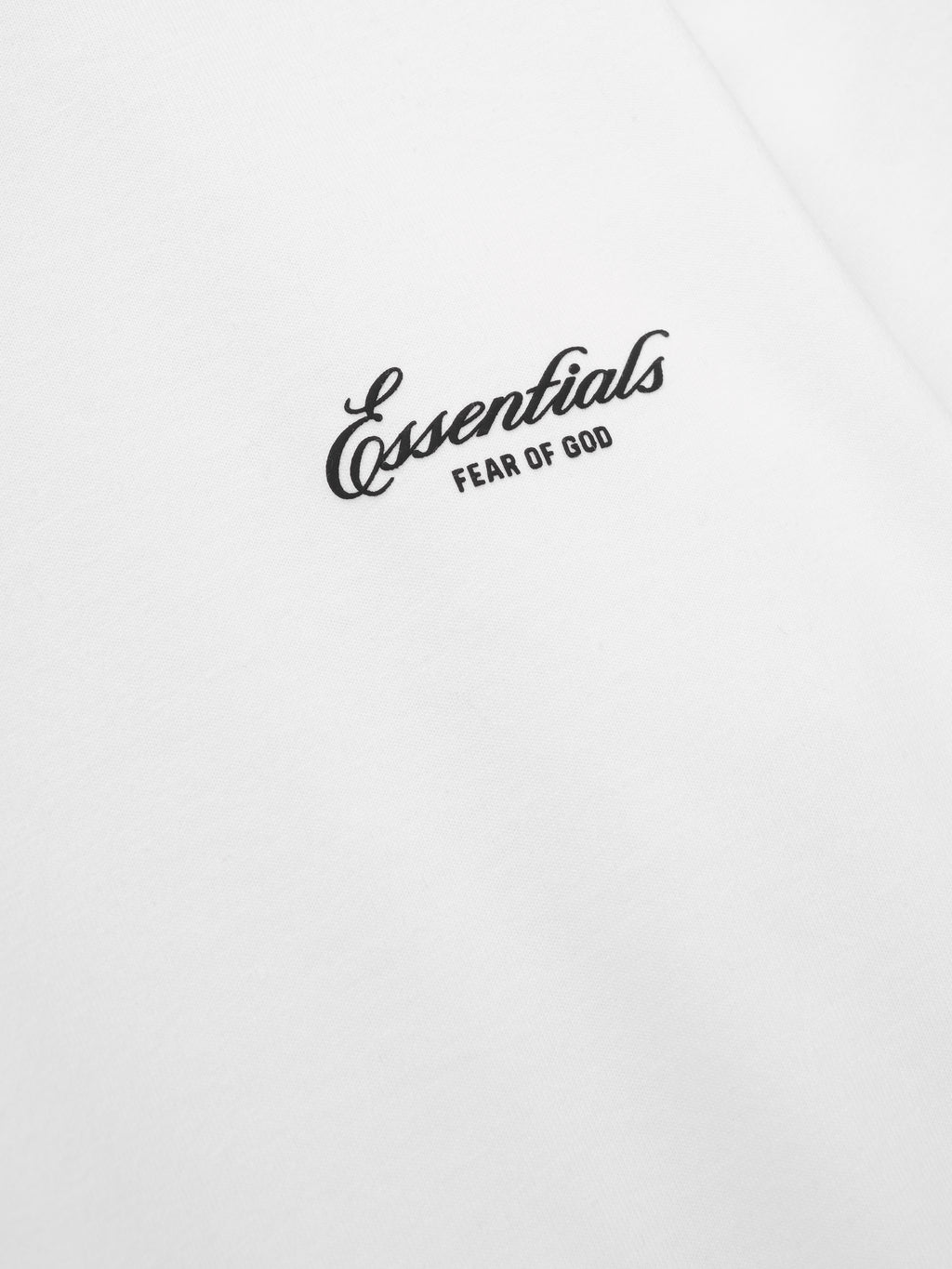 close-up of white cotton jersey fabric with black Essentials Fear of God puff-printed logo on women's tee