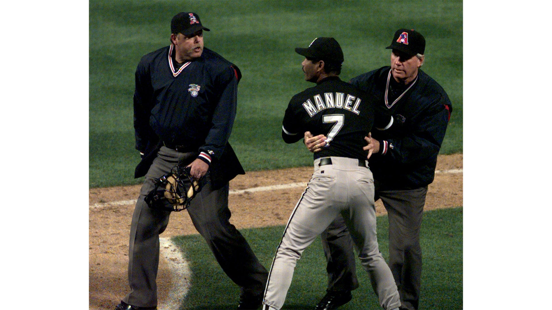 A baseball player wearing a black jersey with the name 