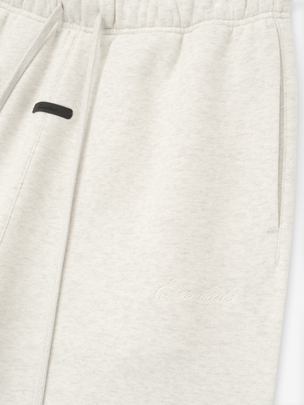 Close-up of a white garment with a black label on a white background