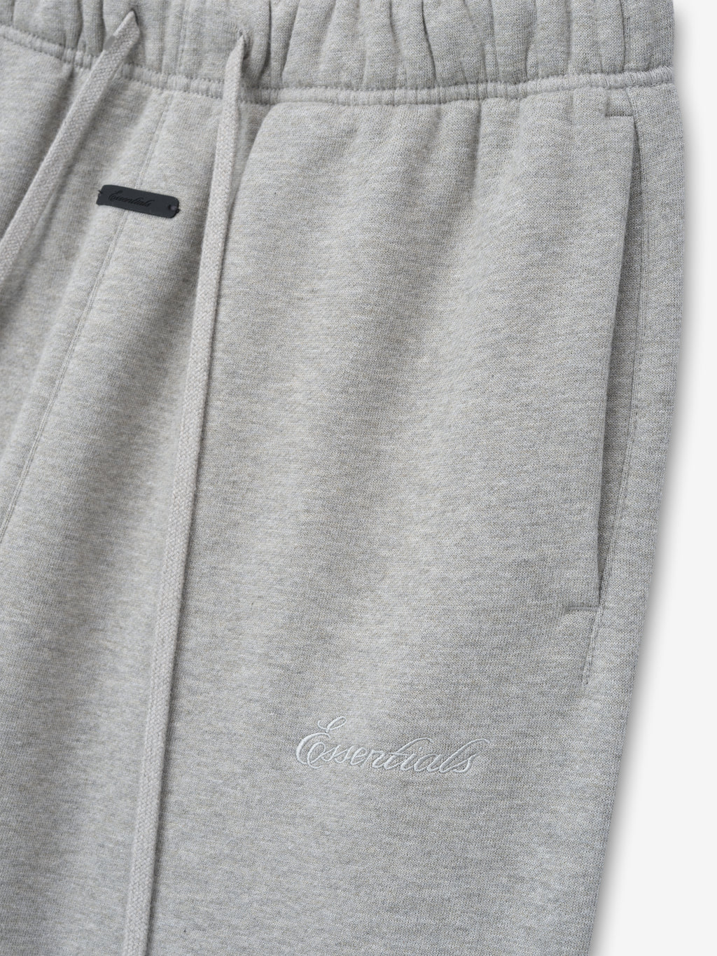 light gray women's classic flare sweatpants made from thick core fleece with elastic waistband and embroidered Essentials logo