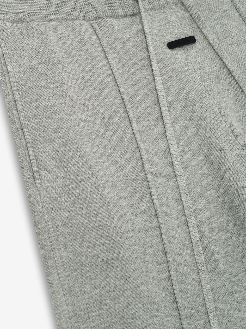 close-up of light grey women's lounge sweatpants in soft jersey knit with relaxed fit and subtle branding detail