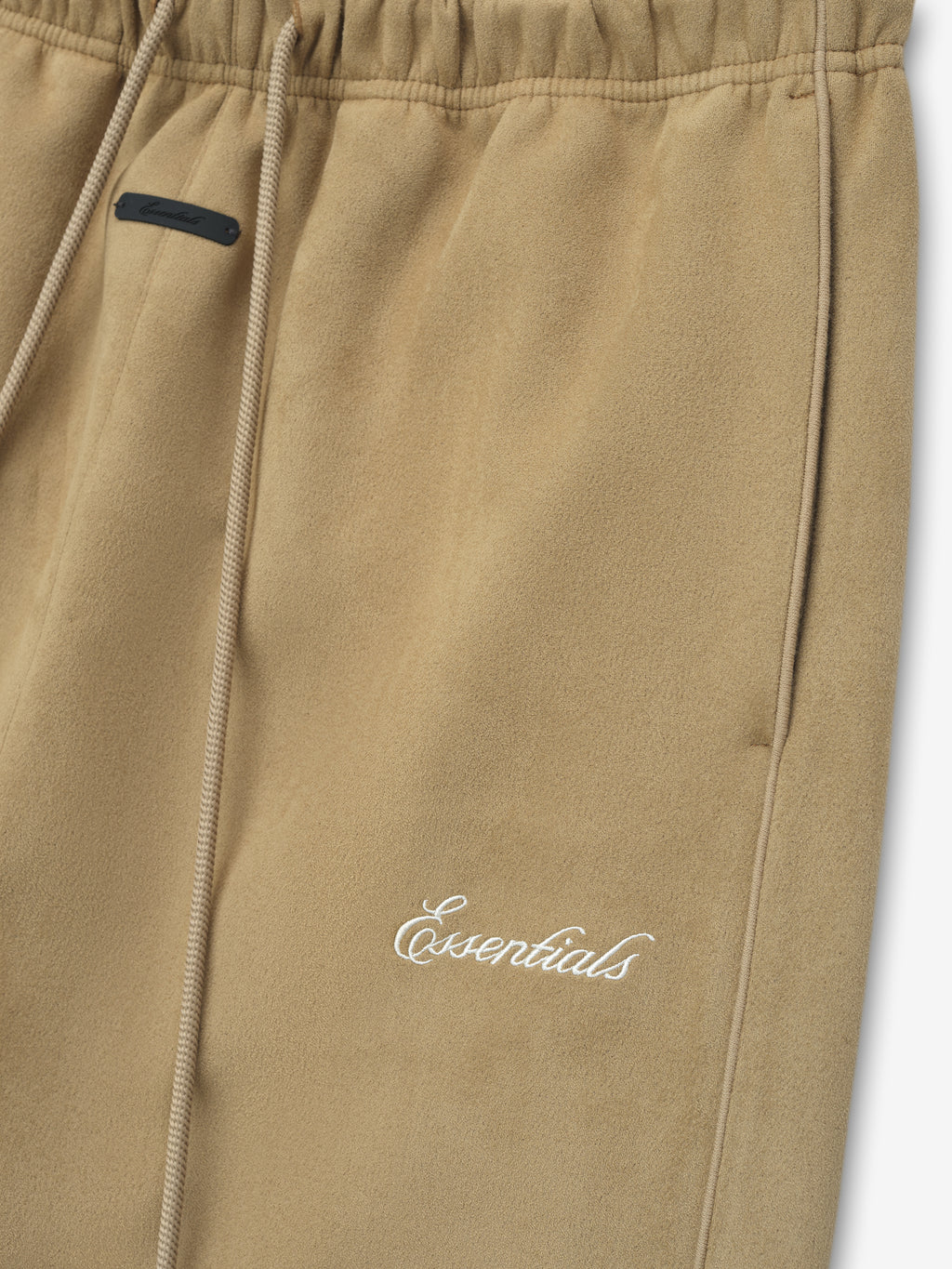 Beige pants with a brand logo on a white background