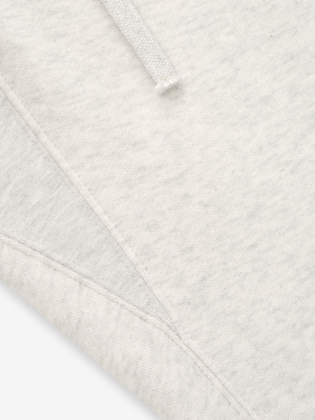 close-up of off-white core fleece fabric and stitching detail on relaxed fit sweatpants with drawstring waistband