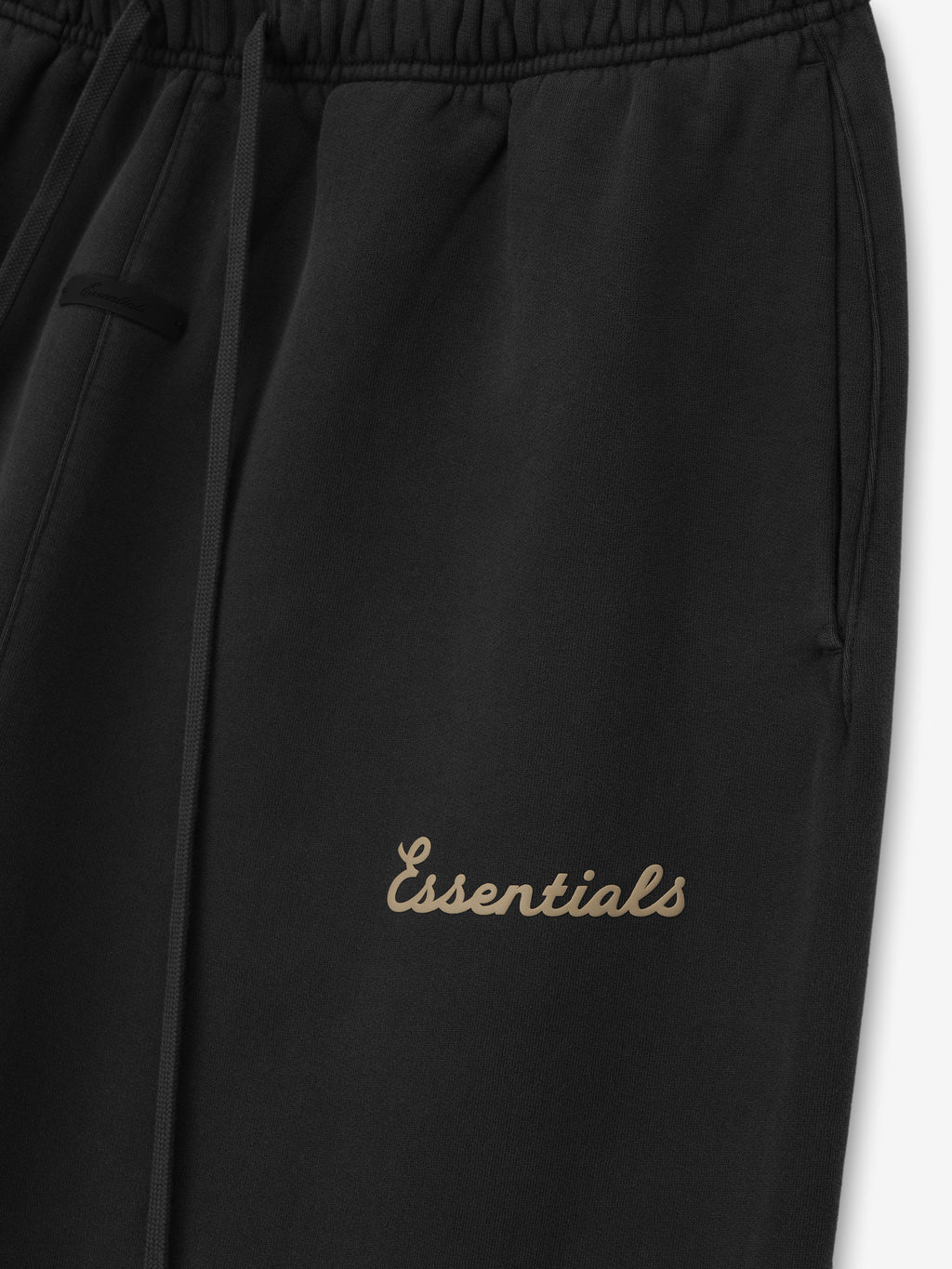 Black pants with 'Essentials' puff print on a white background