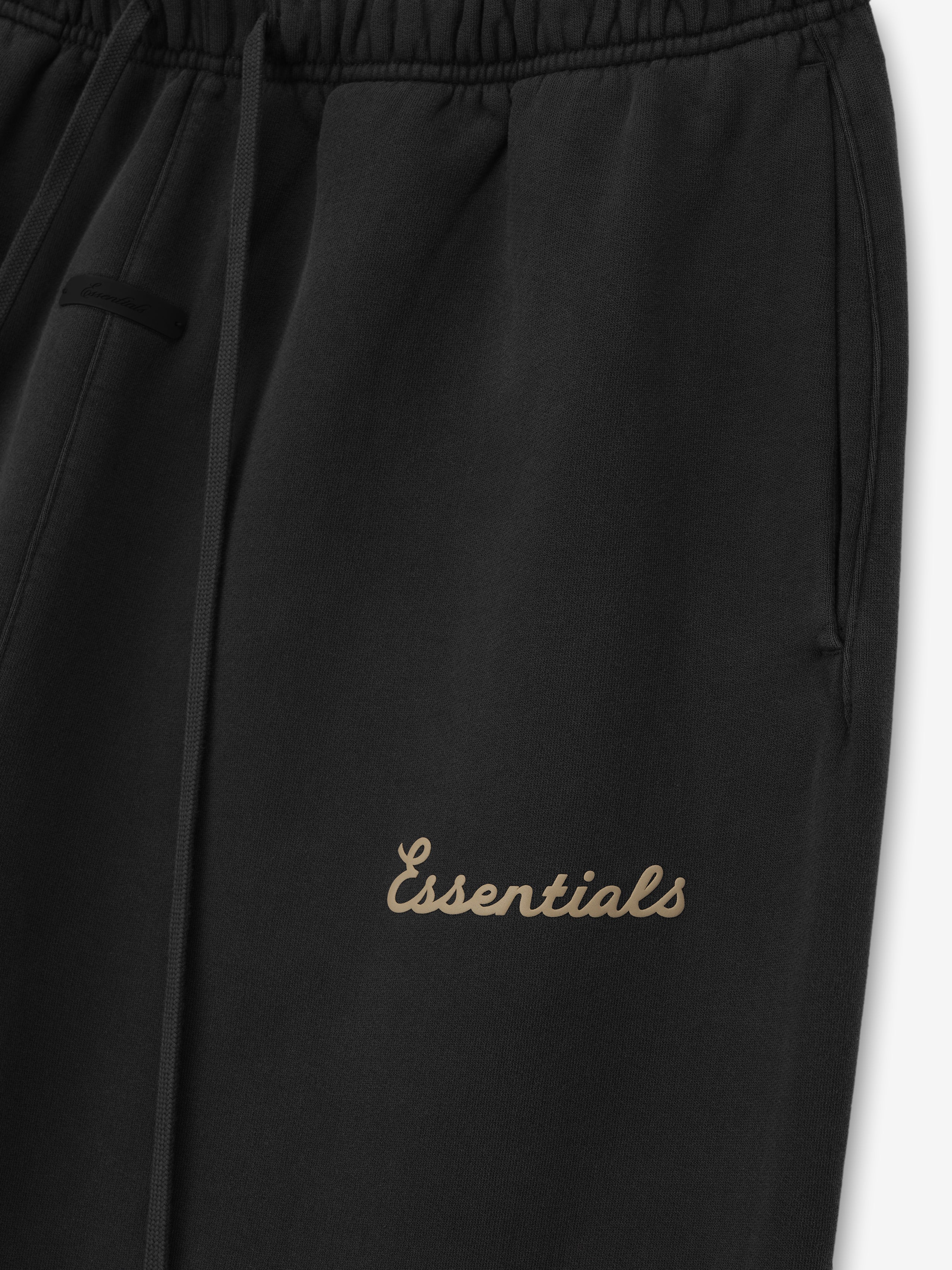 Black pants with 'Essentials' puff print on a white background