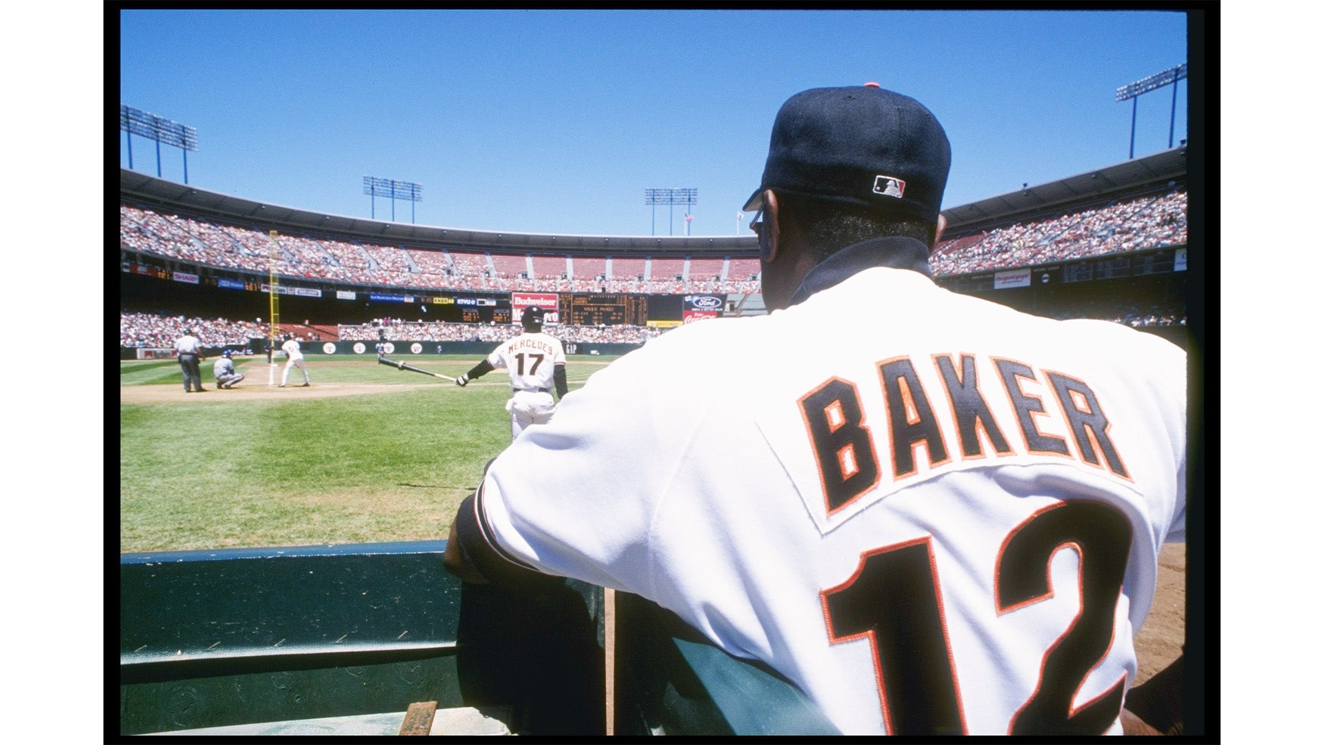 A baseball player wearing a white jersey with the name 