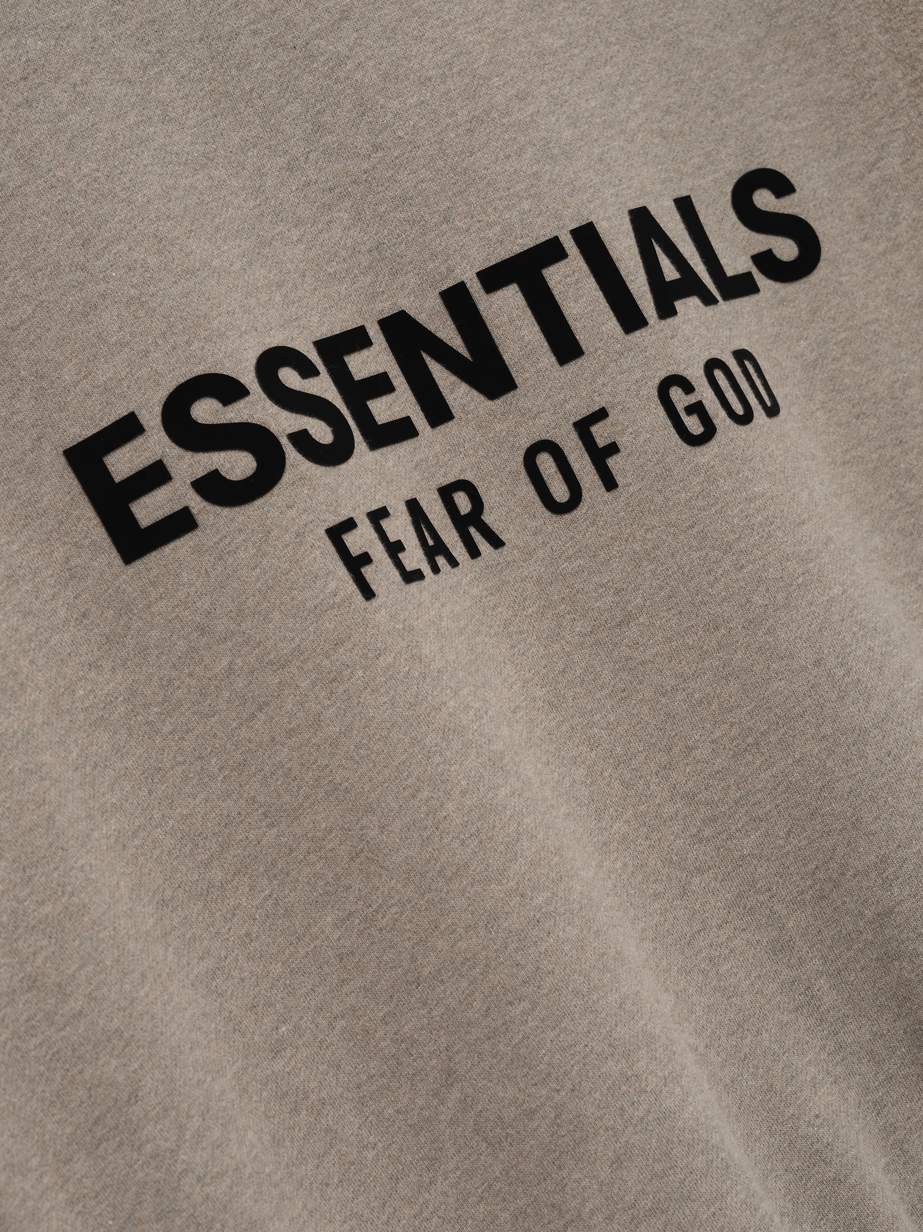 Close-up of Homestead Heather Classic Fit Fleece Crewneck with black Essentials Fear of God logo print