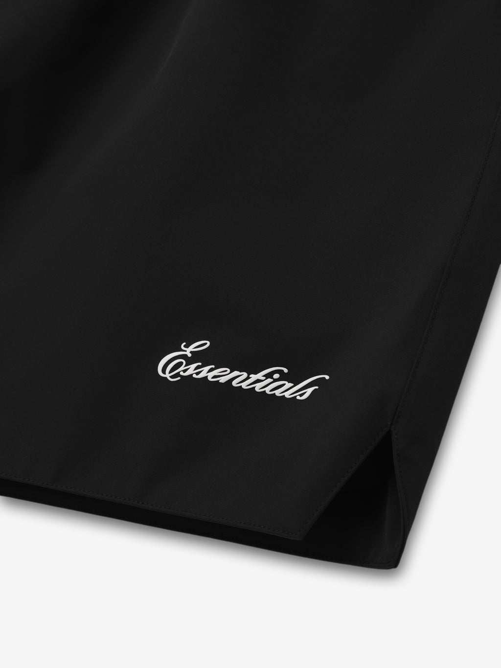 Close-up of black Spurs Classic Short showing white "Essentials" script near hem with side slit in gallery position zero