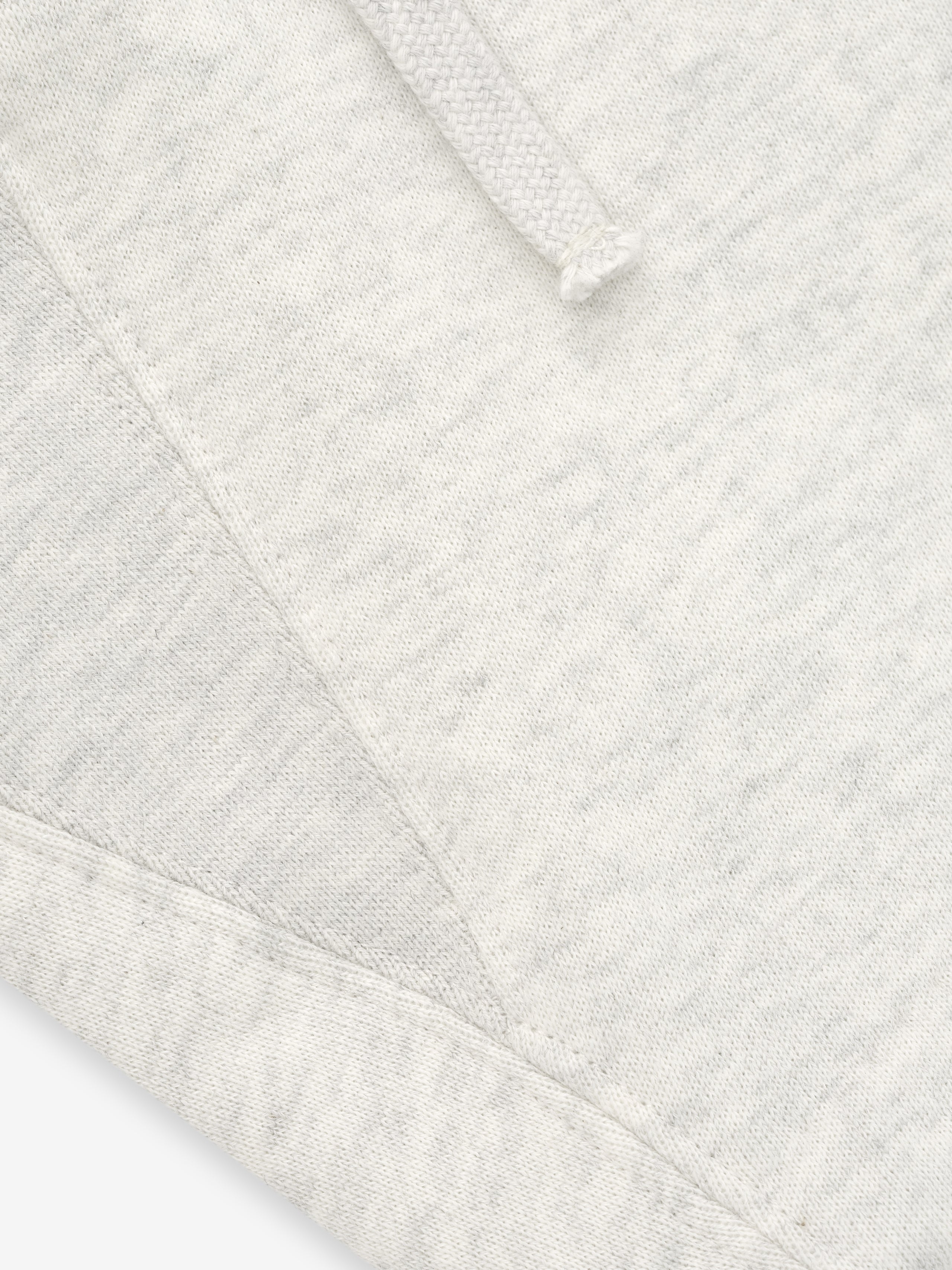 Close-up of a textured white fabric with a diamond pattern
