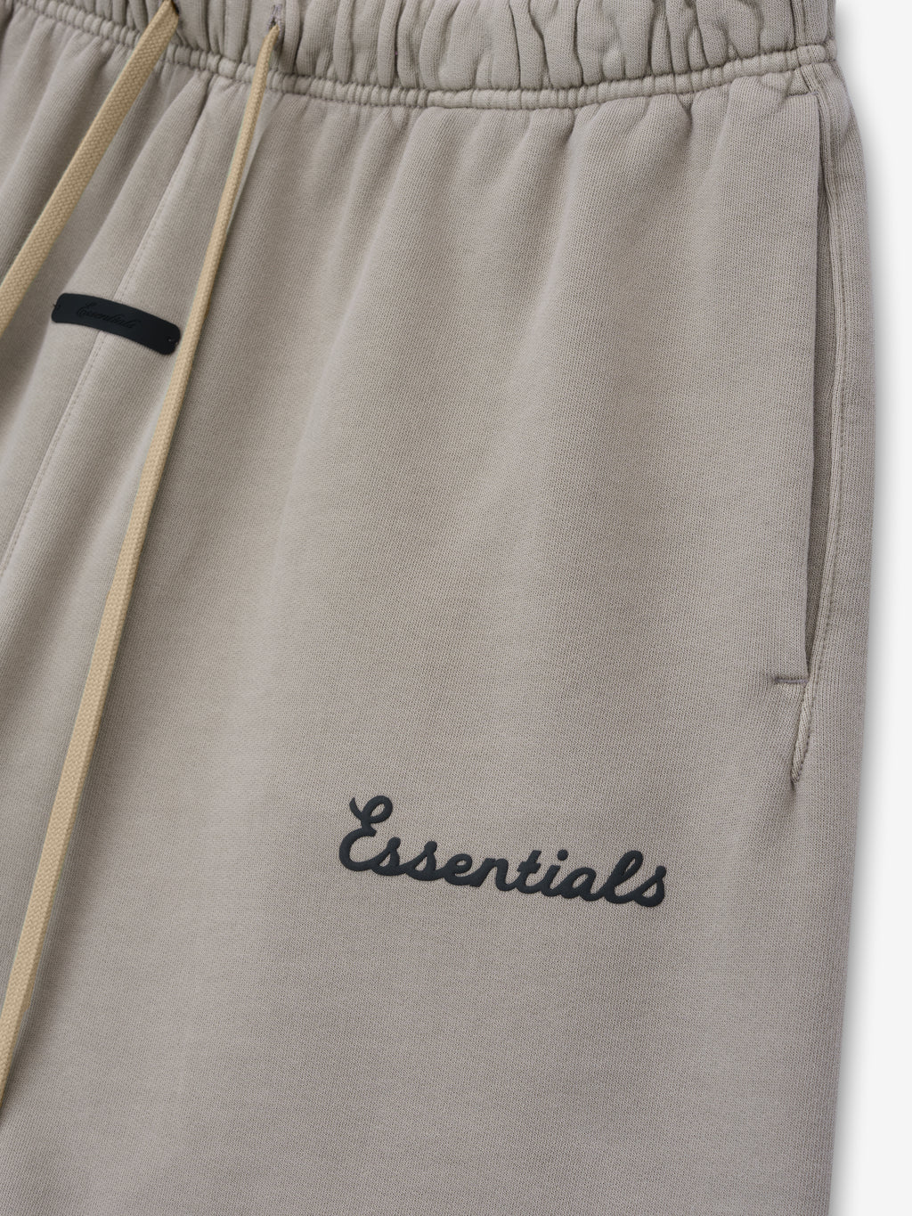 Grey shorts with 'essentials' script puff print logo on leg