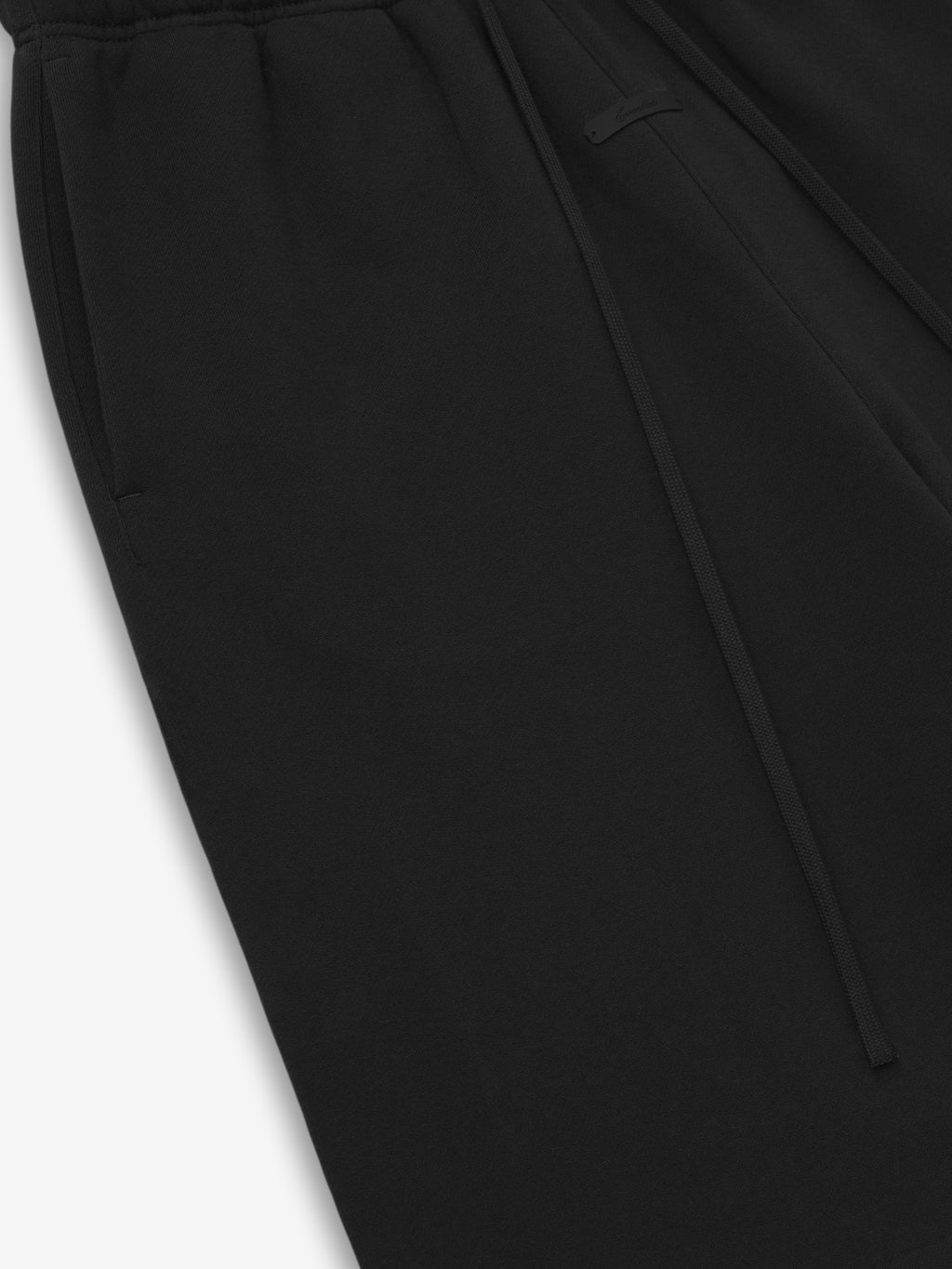 Close-up of black shorts on a light gray background