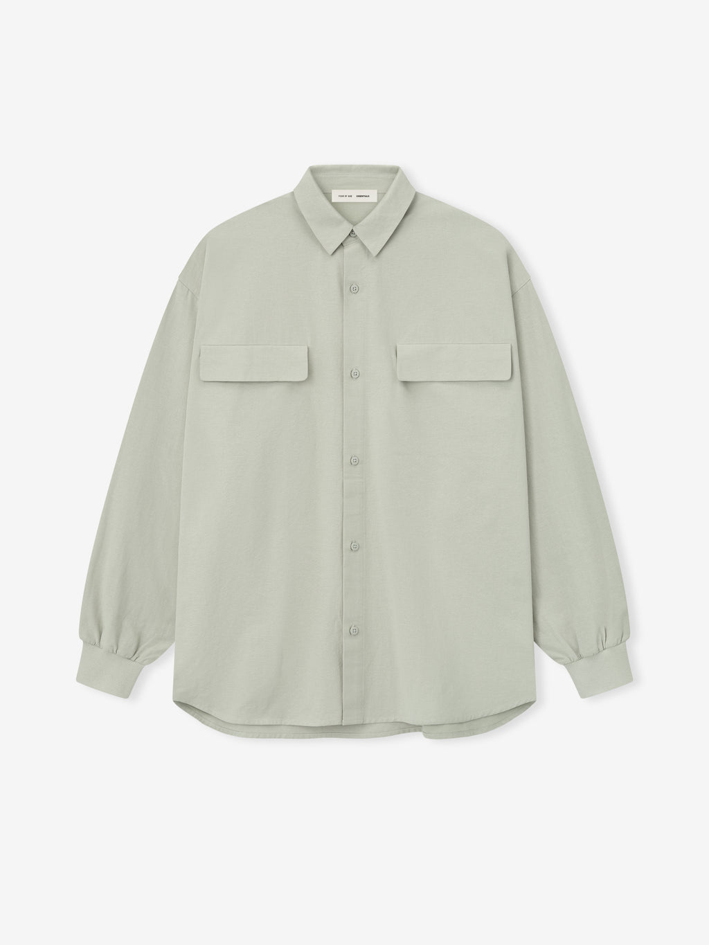 oversized light sage green Oxford shirt with flap chest pockets and buttoned cuffs laid flat on white background