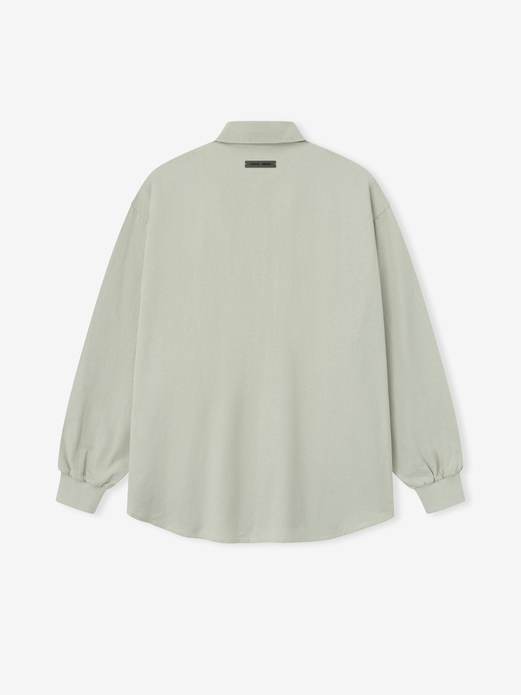 back view of oversized light sage green Oxford shirt with long sleeves and elasticated cuffs on white background