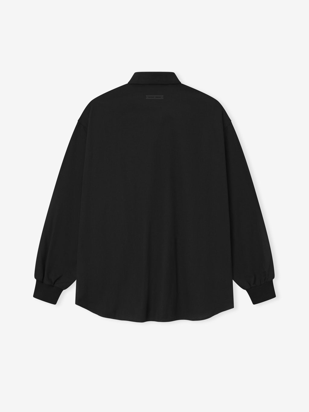 back view of oversized black cotton Oxford shirt with long sleeves and buttoned cuffs on white background