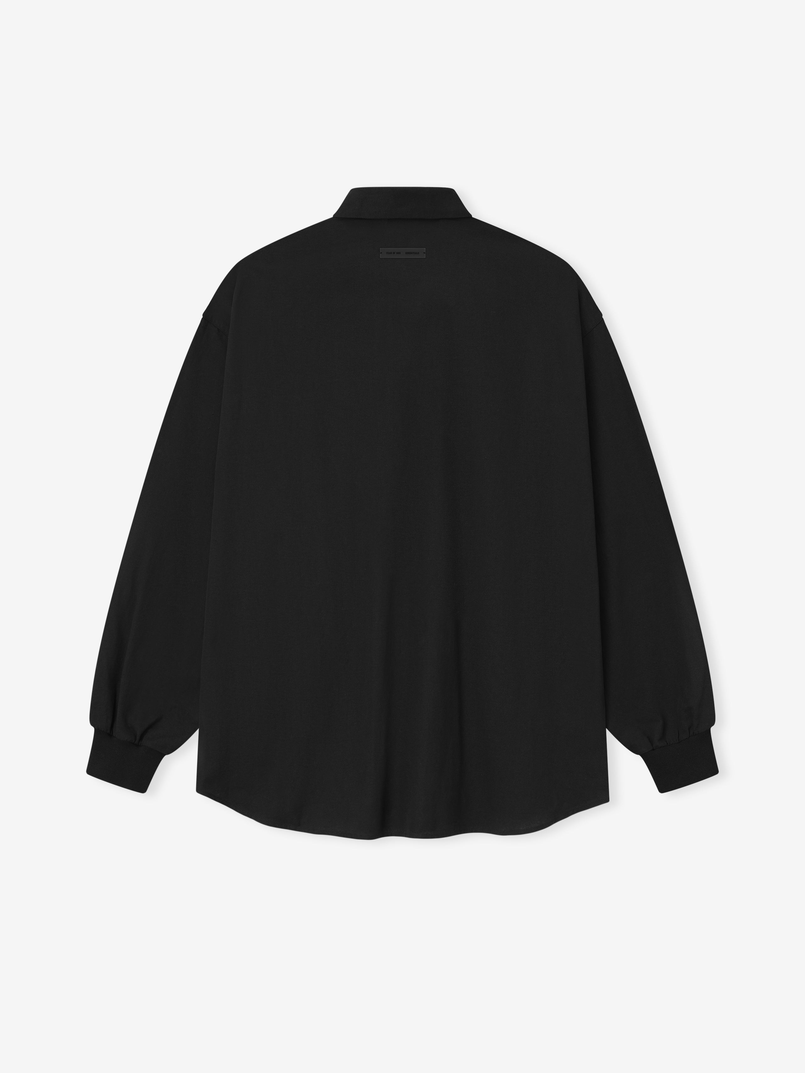 back view of oversized black cotton Oxford shirt with long sleeves and buttoned cuffs on white background