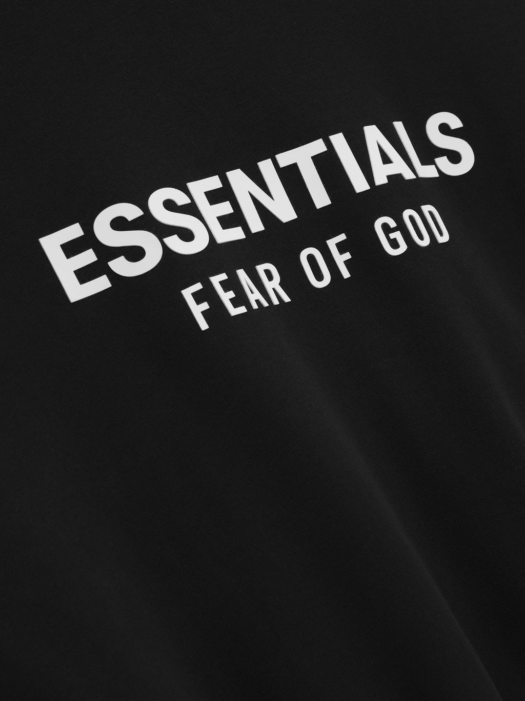 Black hoodie with 'ESSENTIALS FEAR OF GOD' text in white on a black background